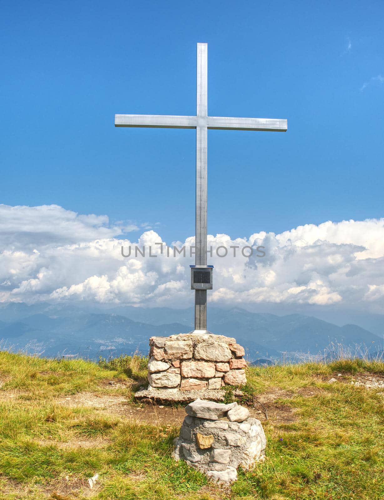 Peak of mountain with cross for memory to victims. Manrvelous day in summer