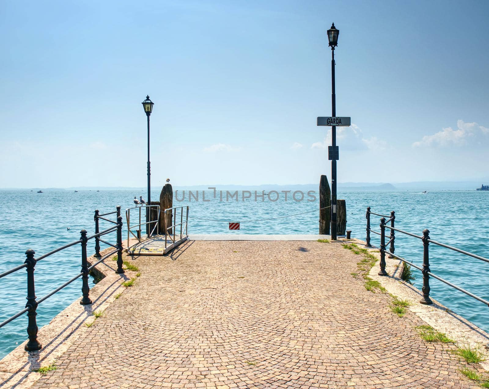 Veiw to the Garda lake from pier, summer holiday in Italy. 