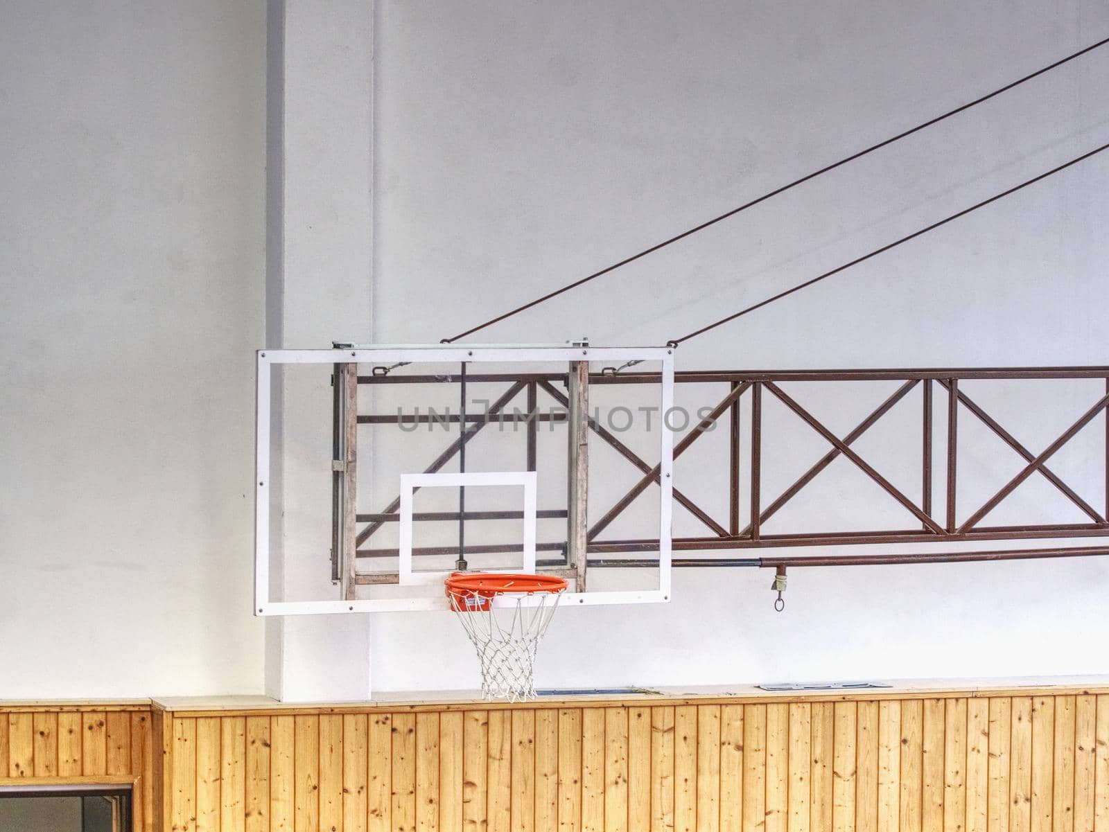 Basketball transparent backboard with basket in the gym. White background. 