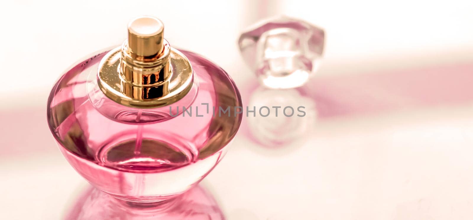 Pink perfume bottle on glossy background, sweet floral scent, glamour fragrance and eau de parfum as holiday gift and luxury beauty cosmetics brand design by Anneleven