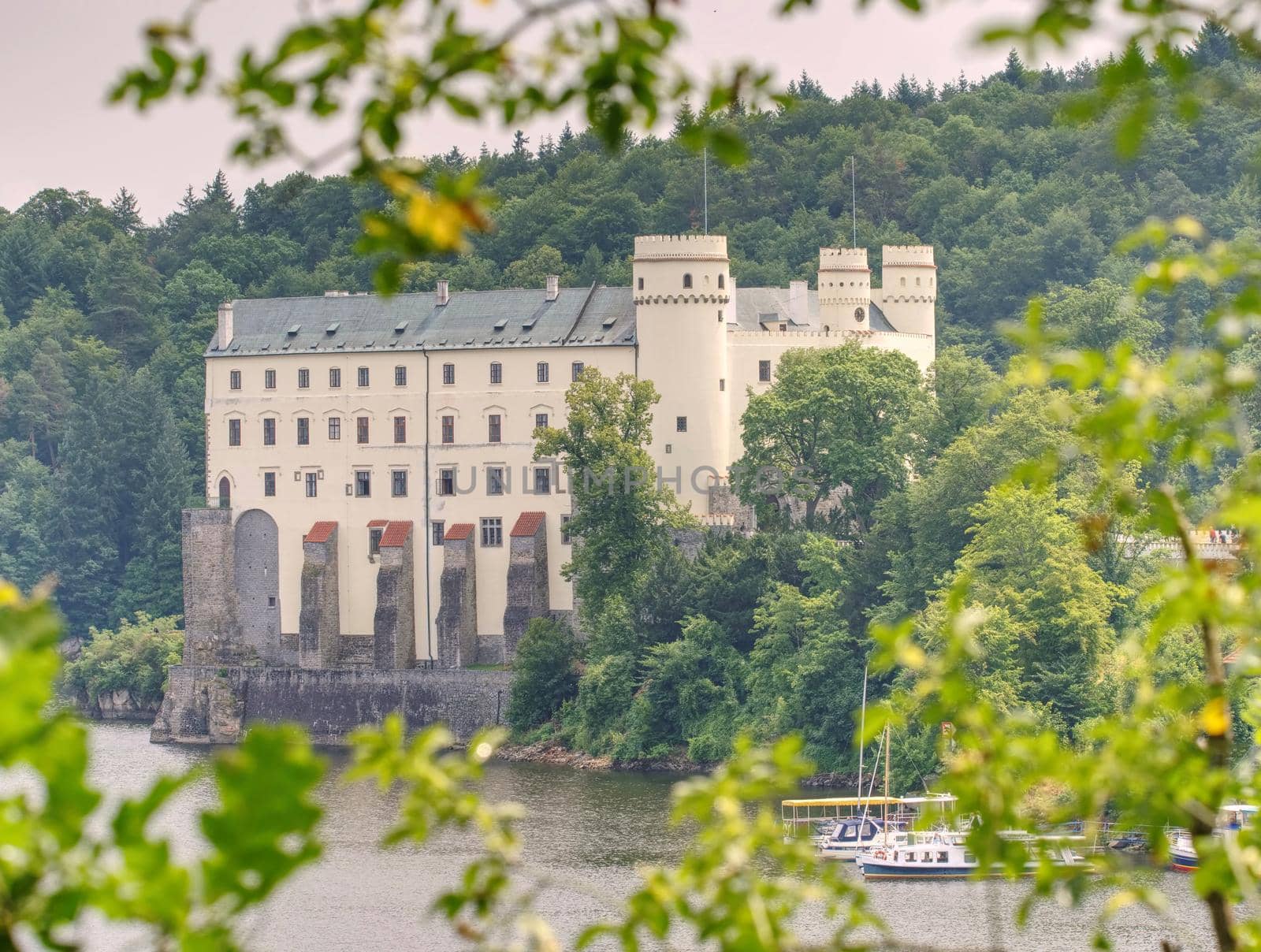 Orlik castle or chateau above water of Orlik dam. Popular Schwarzenberg medieval stronghold in the Southern Bohemia, Czech Republic