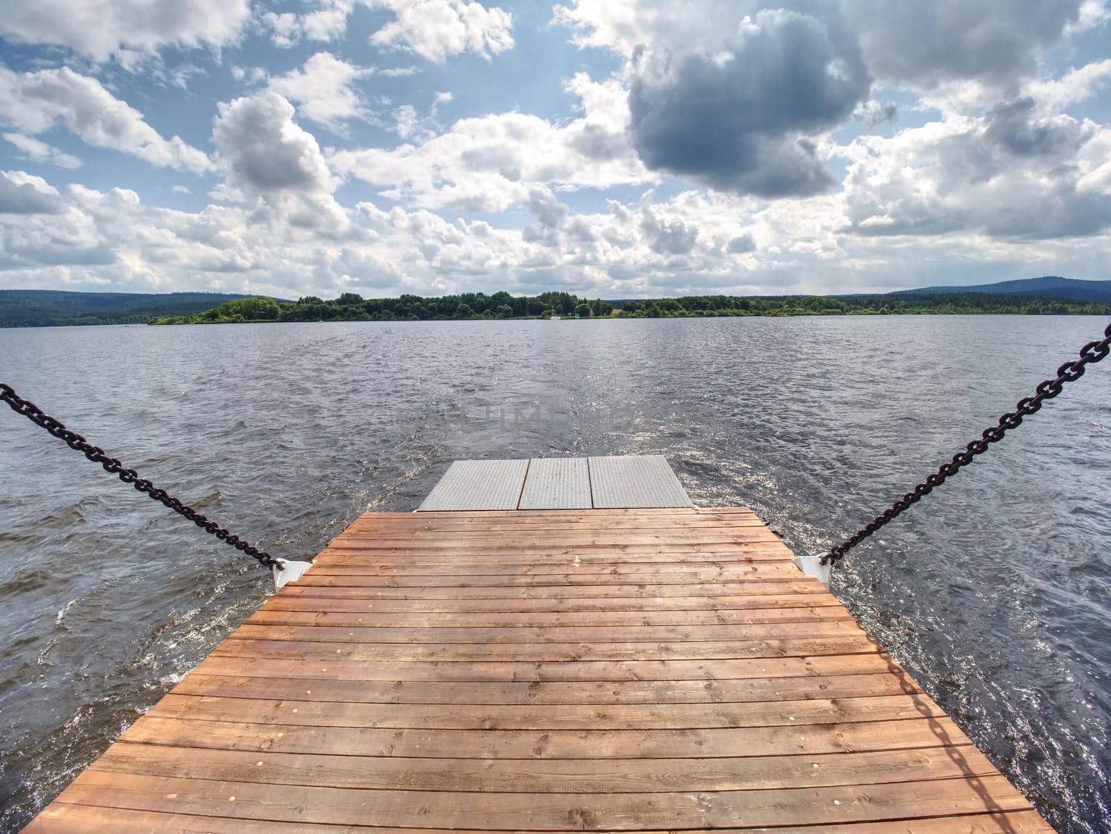 View over ferry metal boat against the wavy lake water by rdonar2