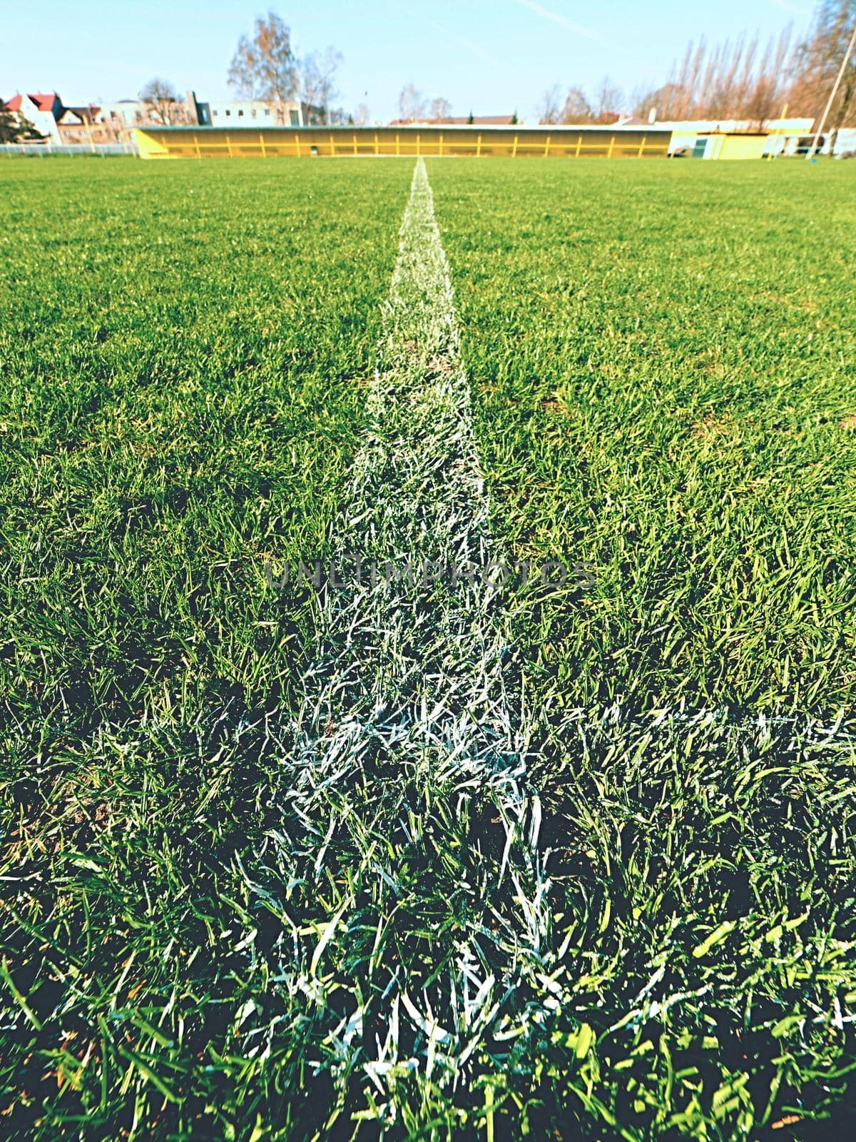 Border of painted white lines on natural dry football grass. Cut green turf texture.  by rdonar2
