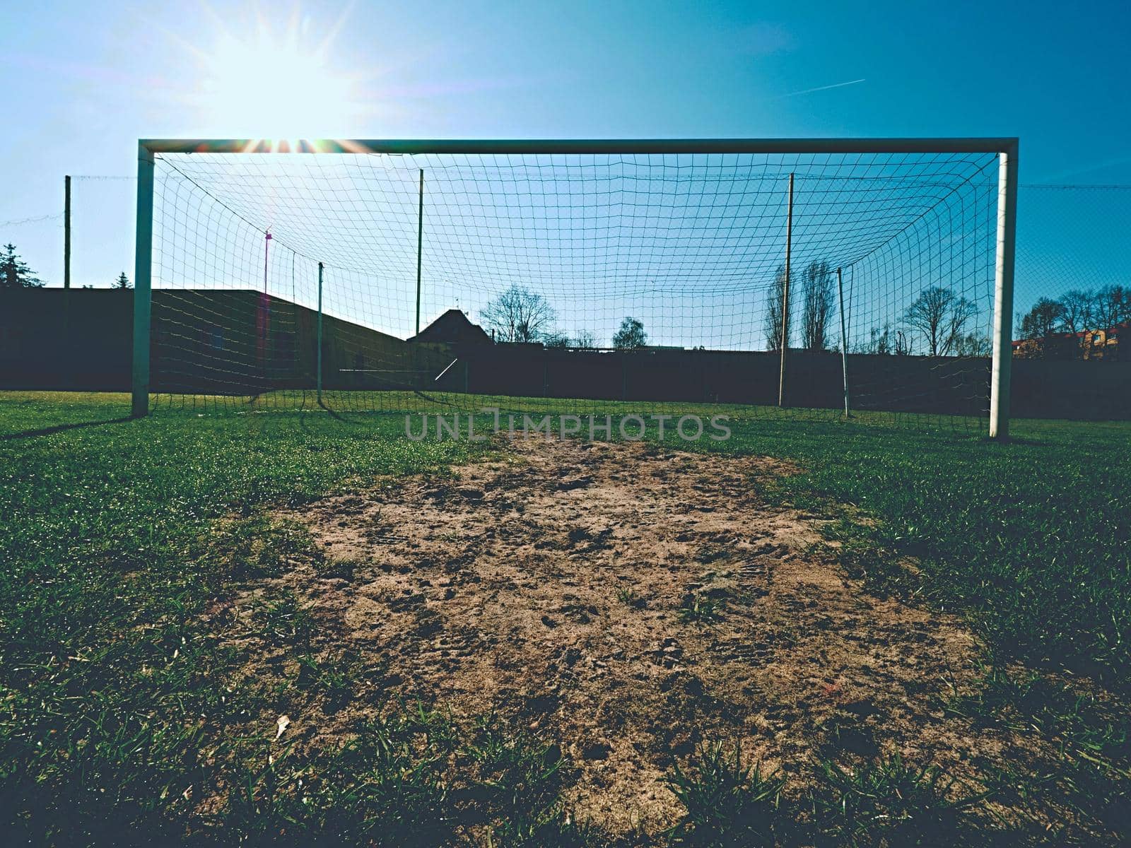 Soccer football net background over green grass and blurry stadium. by rdonar2