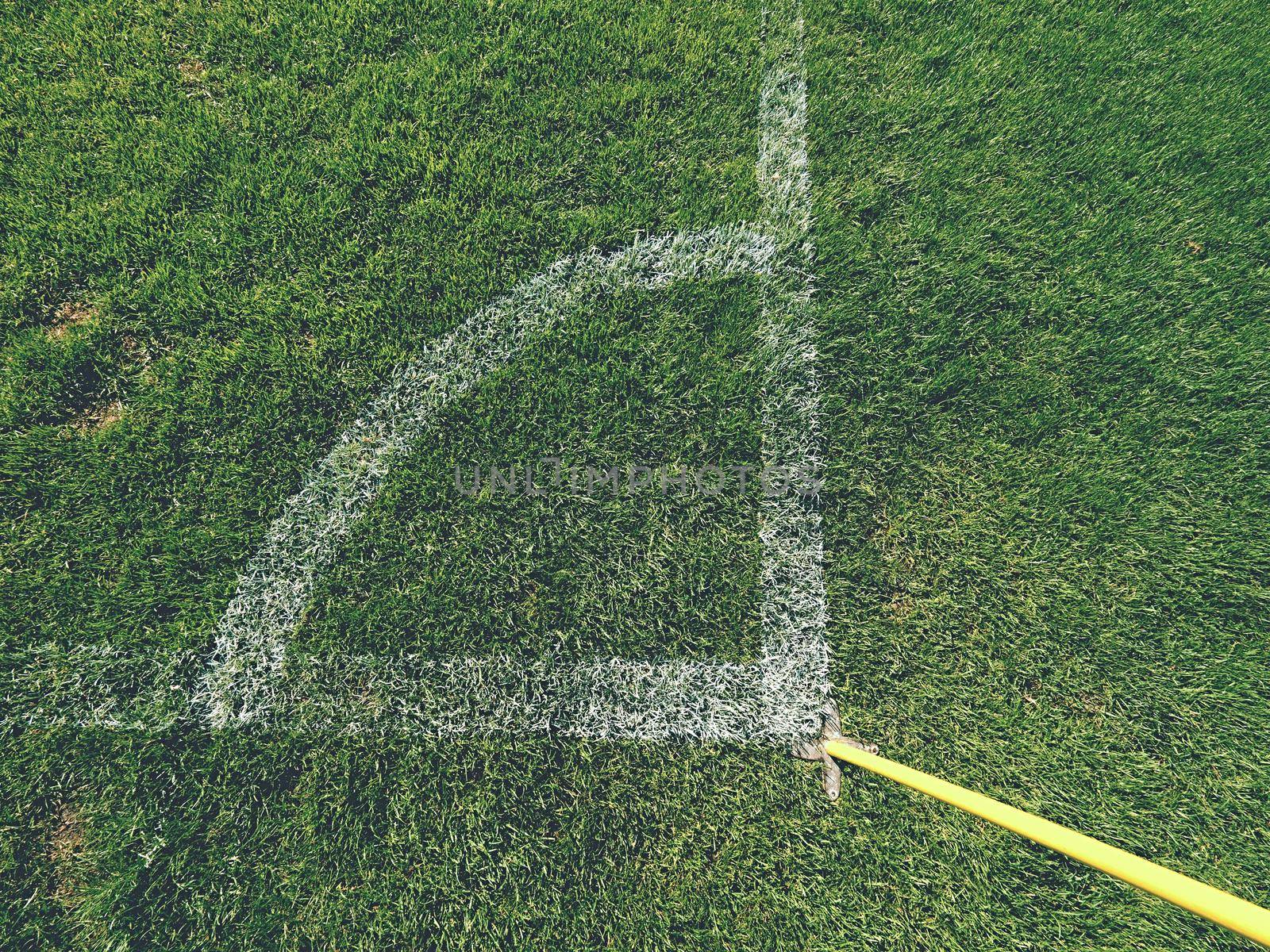 Football field corner detail with white marks and flag stick