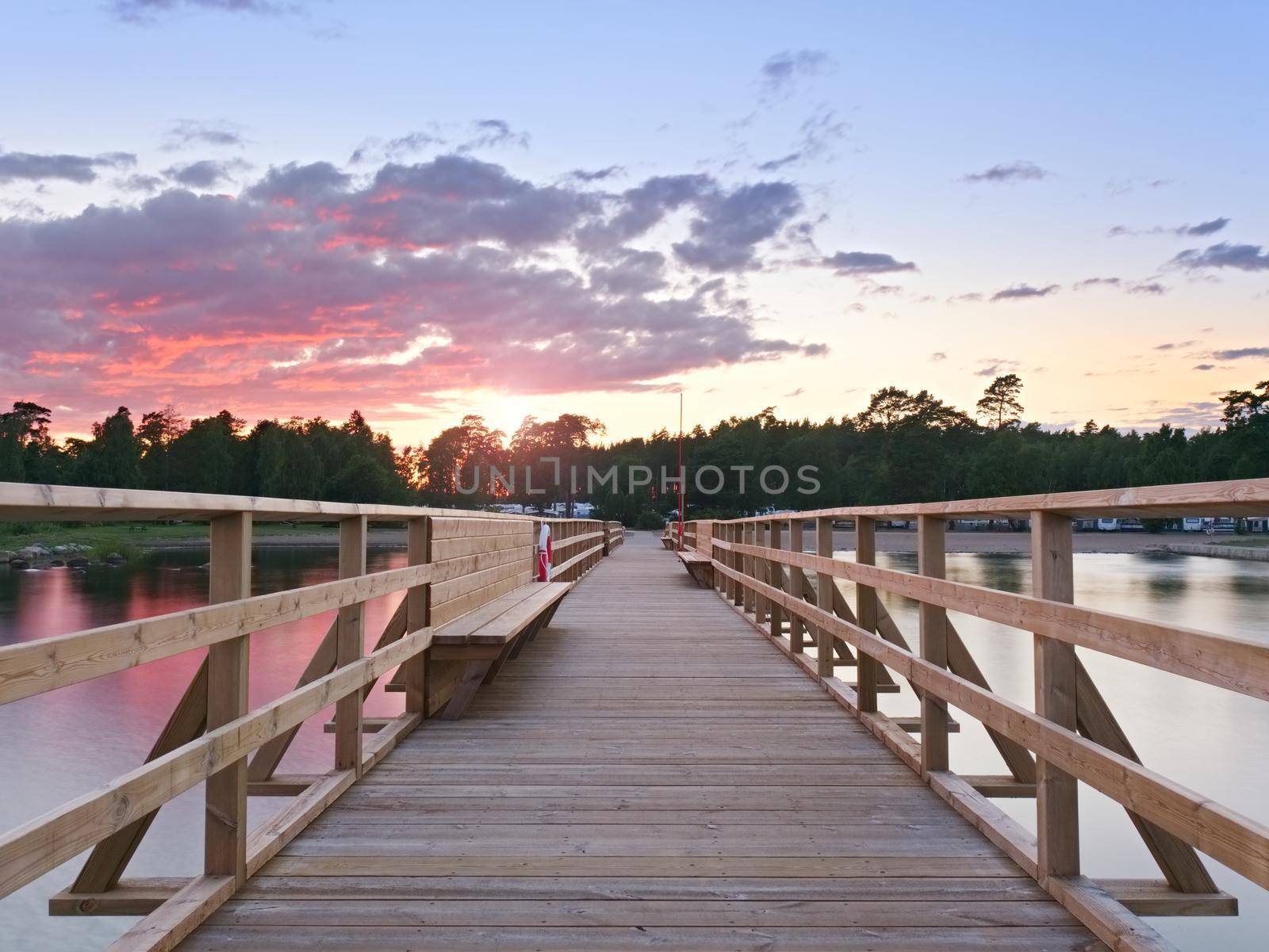 Long wooden pier on the Baltic coast during morning. Cold weather, cold water. New built attraction in summer holiday resort. Empty mole.
