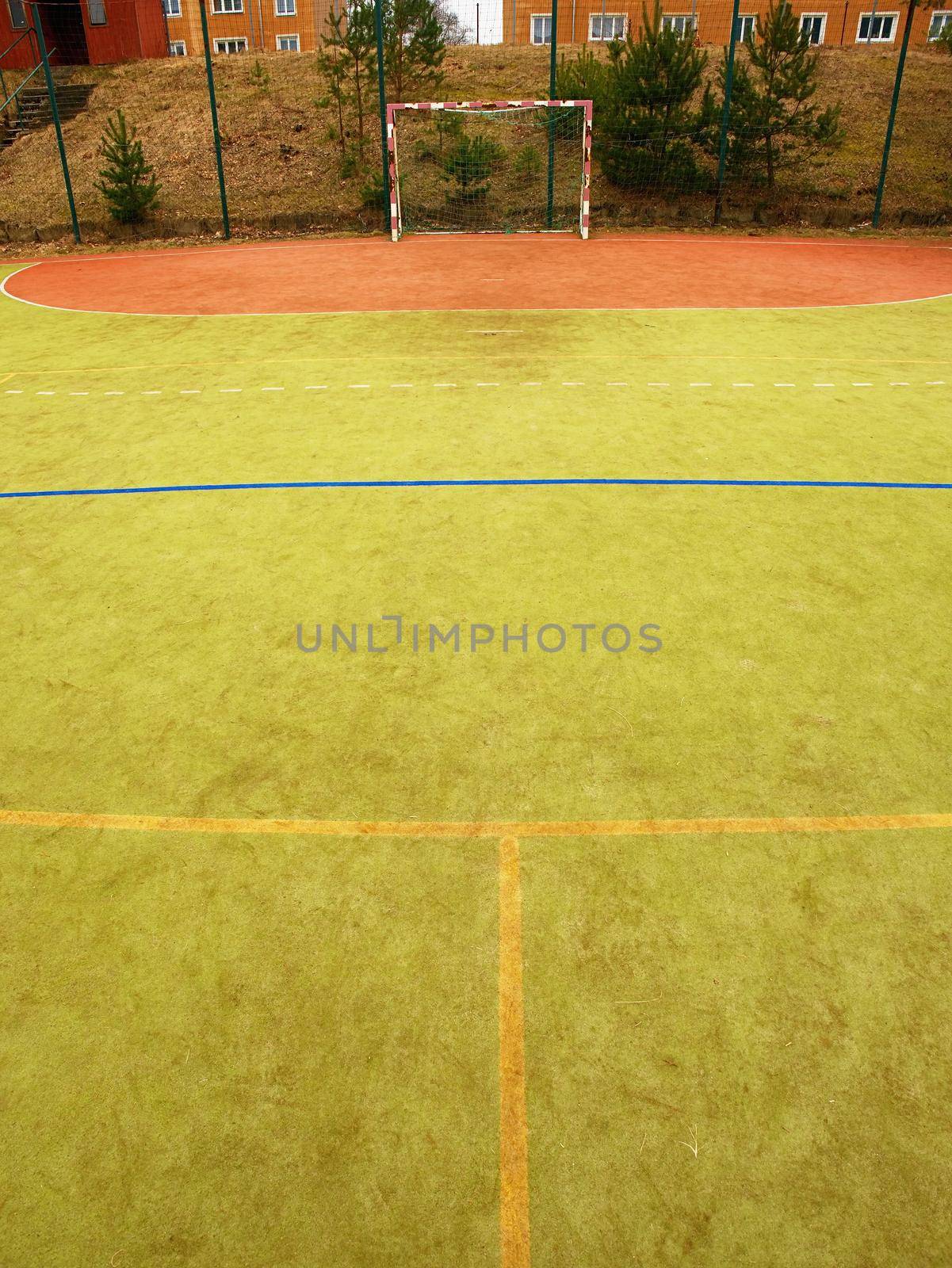 Empty gate. Outdoor football or handball playground plastic light green surface by rdonar2