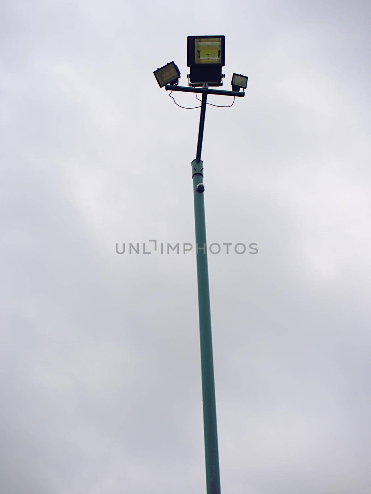 Lonely stadium light or lamp post with Union of light bulb standing alone  by rdonar2