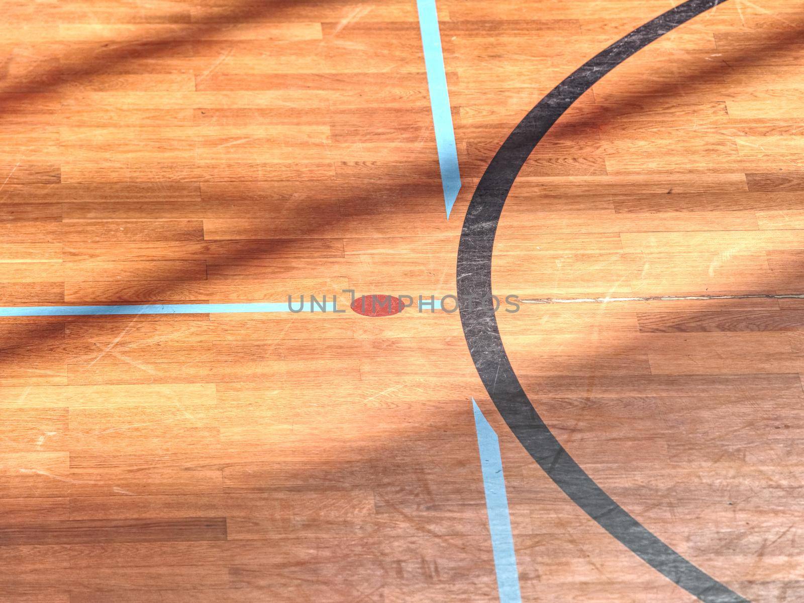 Playfield lines painted on renewal gymnasium wooden floor. Inside athletic playground