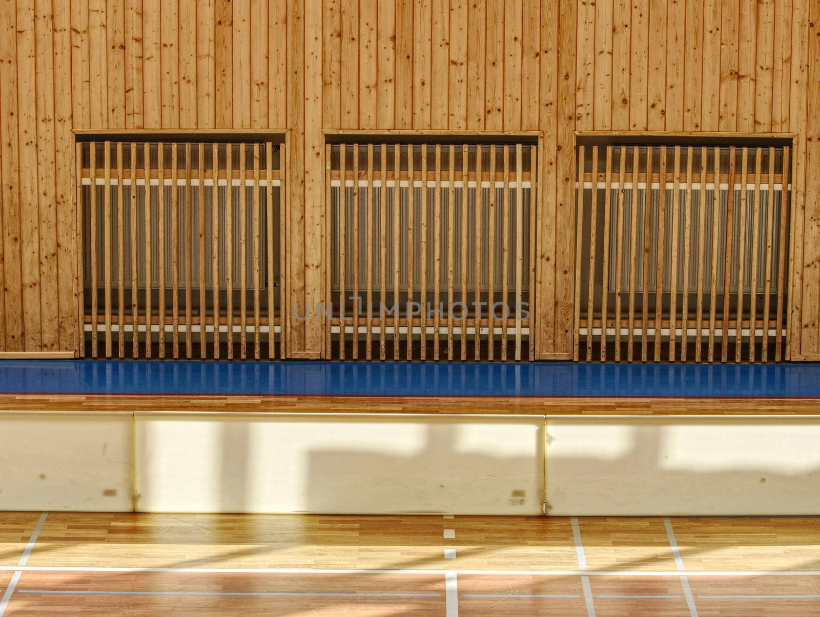 Schooll gym hall with heating system over wooden bars cover by rdonar2