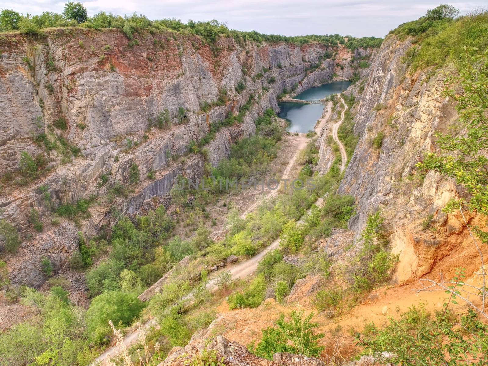 Grand canyon ov abandoned quarry of dolomite source mine. Beautiful quarry with blue water. Water reservoir  