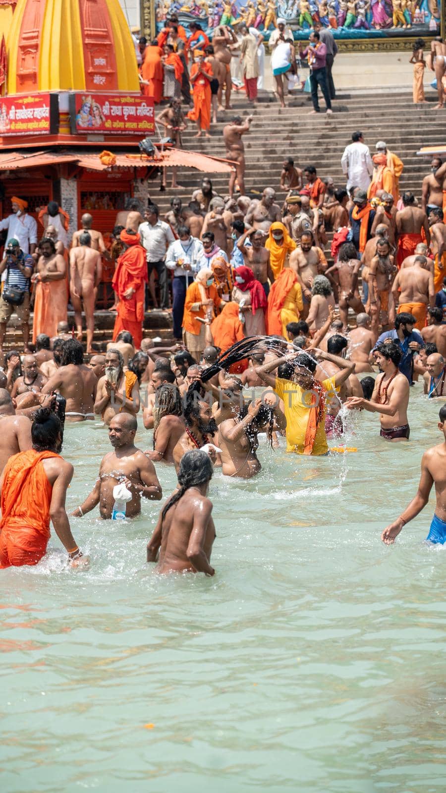 Haridwar, Uttarakhand India April 06, 2021. A Dip of Spirituality and faith, Maha Kumbh 2021. Morning Time dip, Indian saints batting in Ganges of Ganga River and Worshipping their God. High-quality