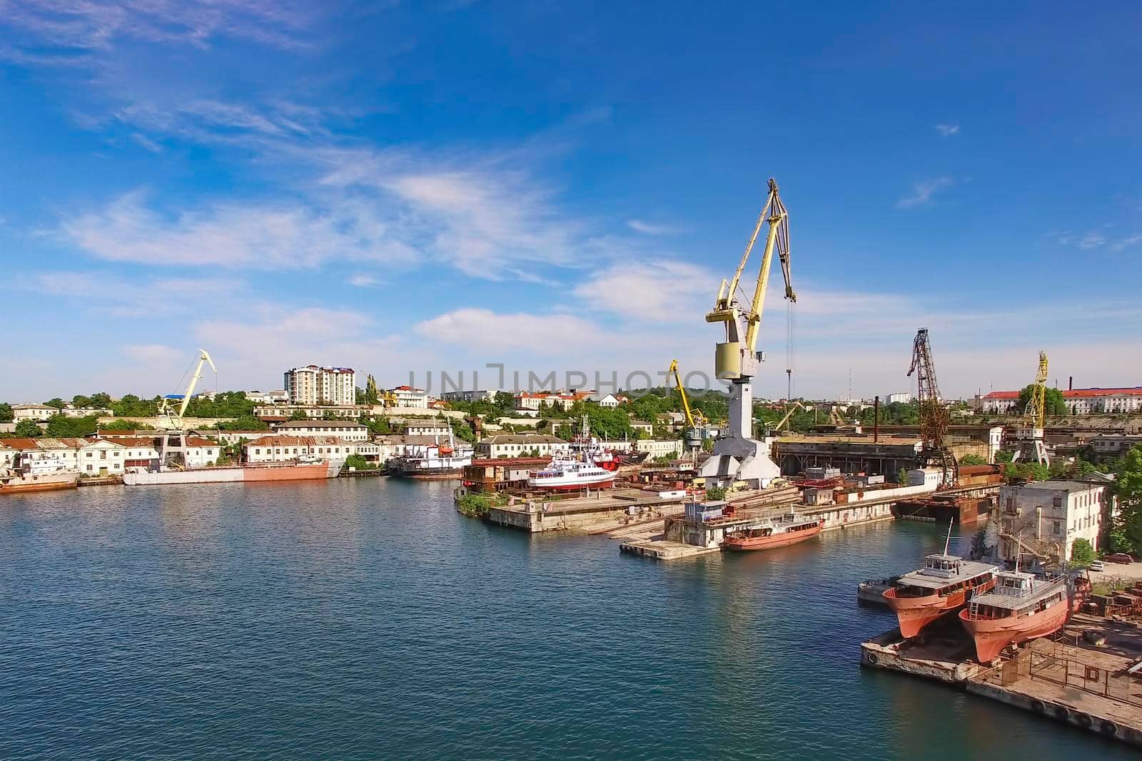 Aerial view of the cityscape overlooking the port with ships and cranes. Sevastopol, Crimea