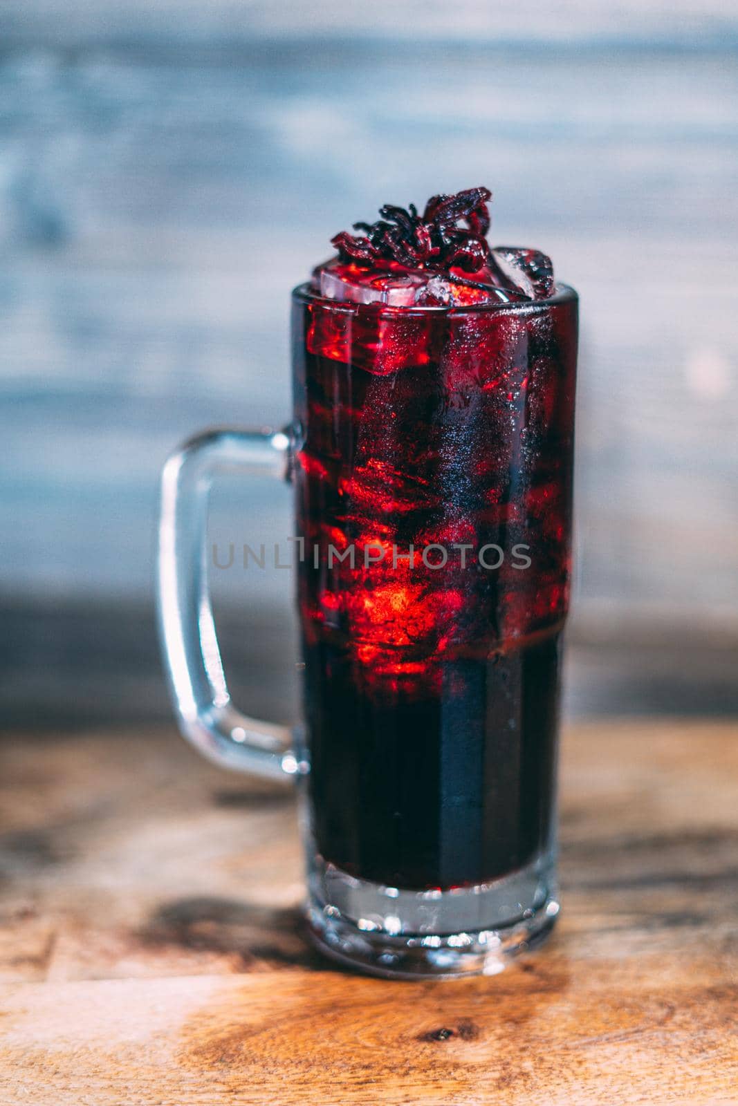 A glass of dark juice cocktail drink