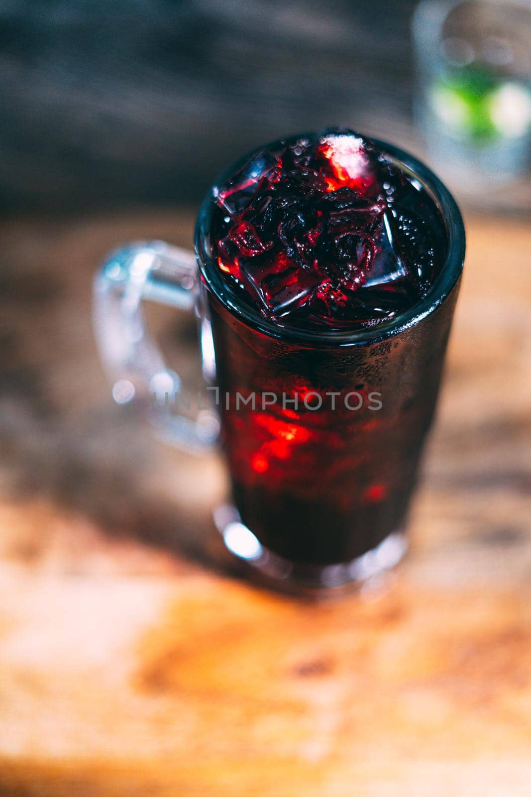 A glass of dark juice cocktail drink