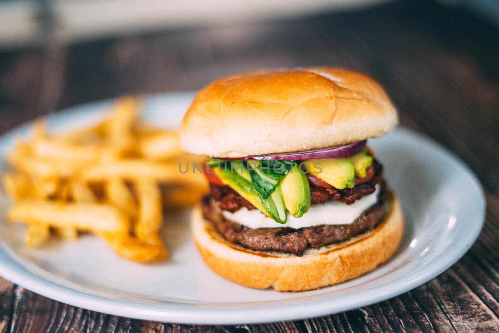 A plate of juicy hamburger and fries