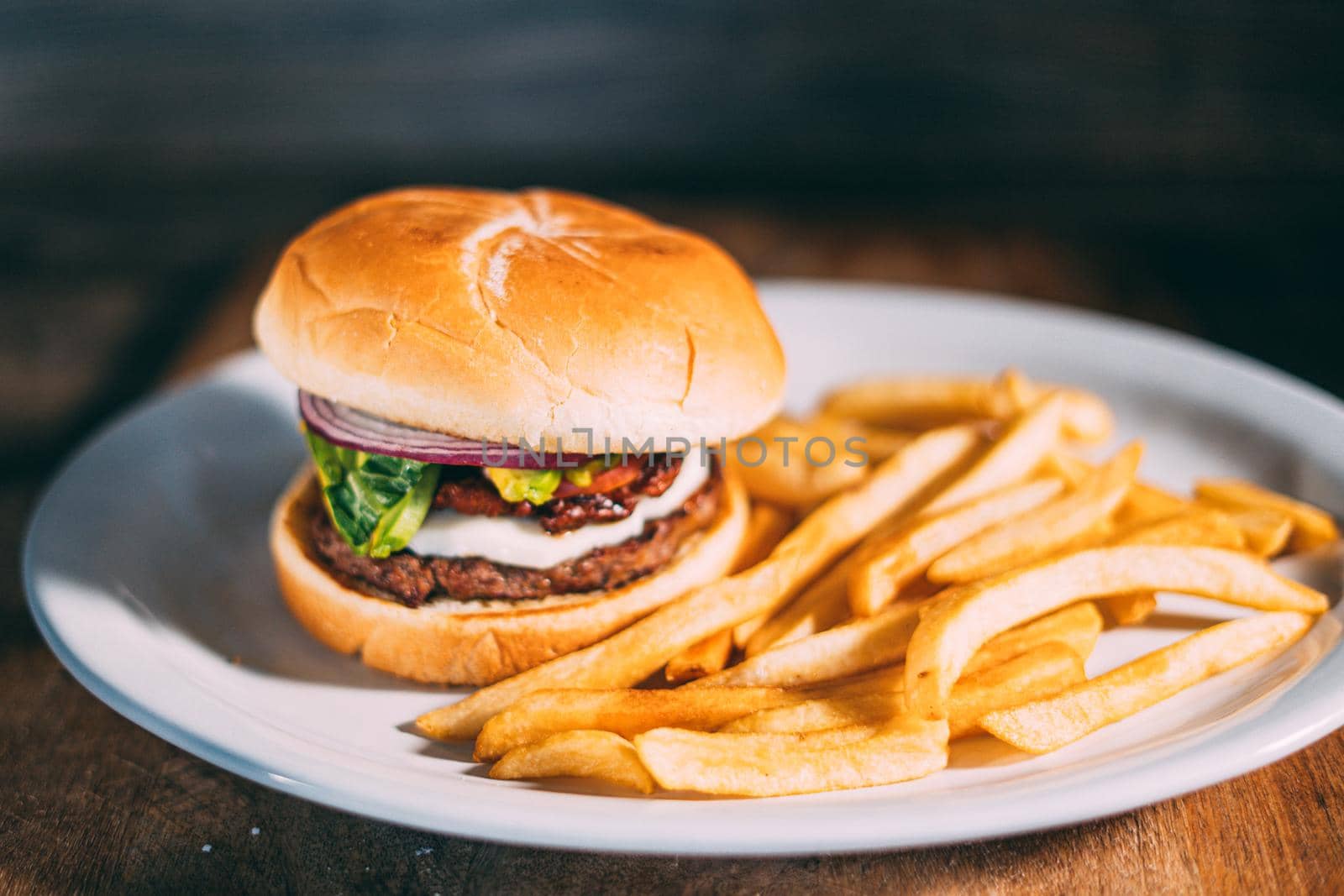 A plate of juicy hamburger and fries