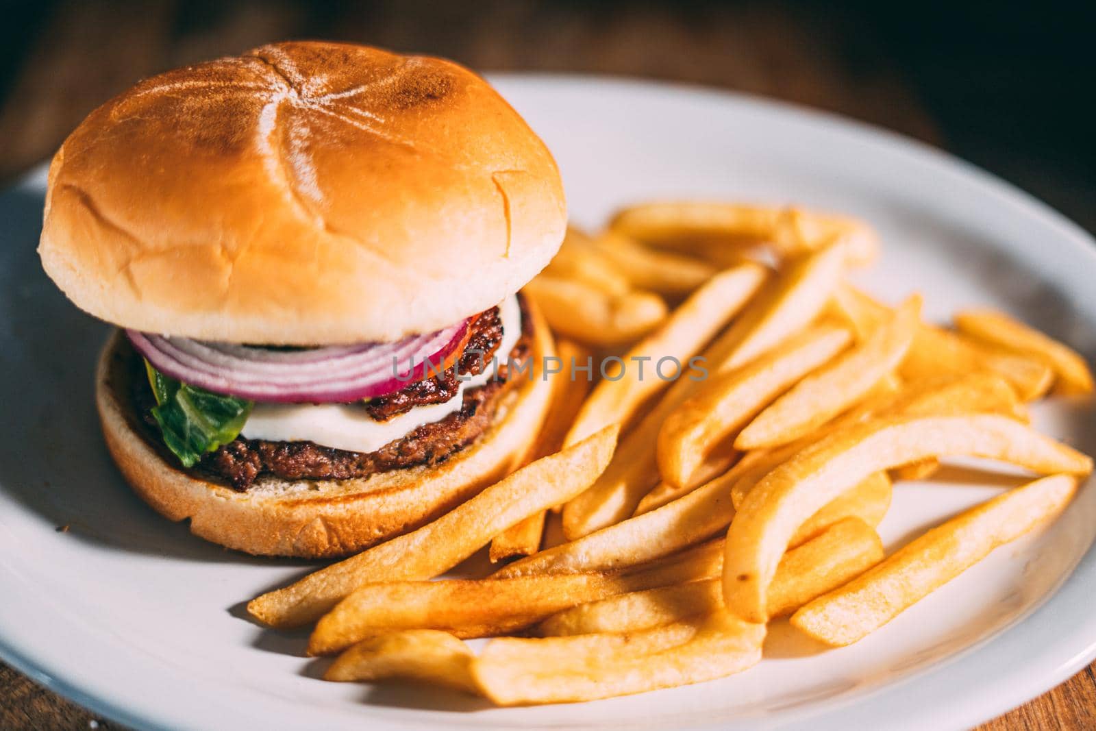 A plate of juicy hamburger and fries