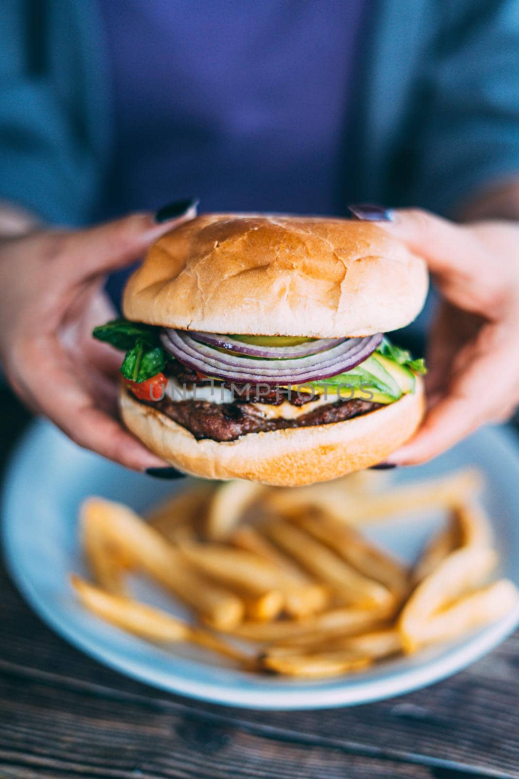 A plate of juicy hamburger and fries