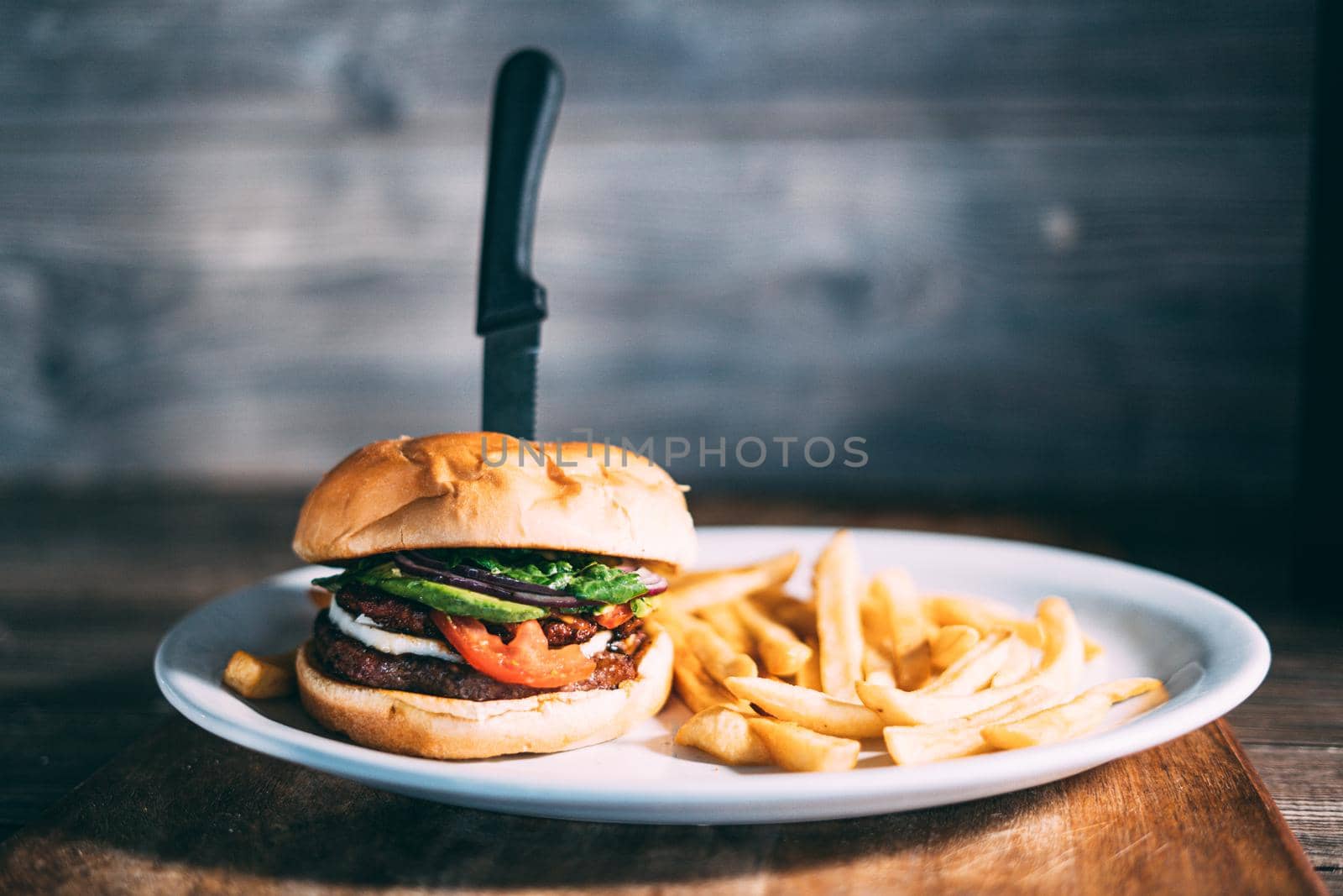 A plate of juicy hamburger and fries