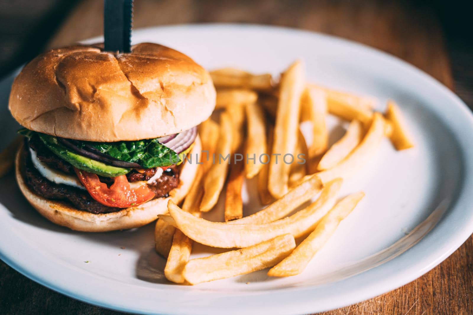 A plate of juicy hamburger and fries