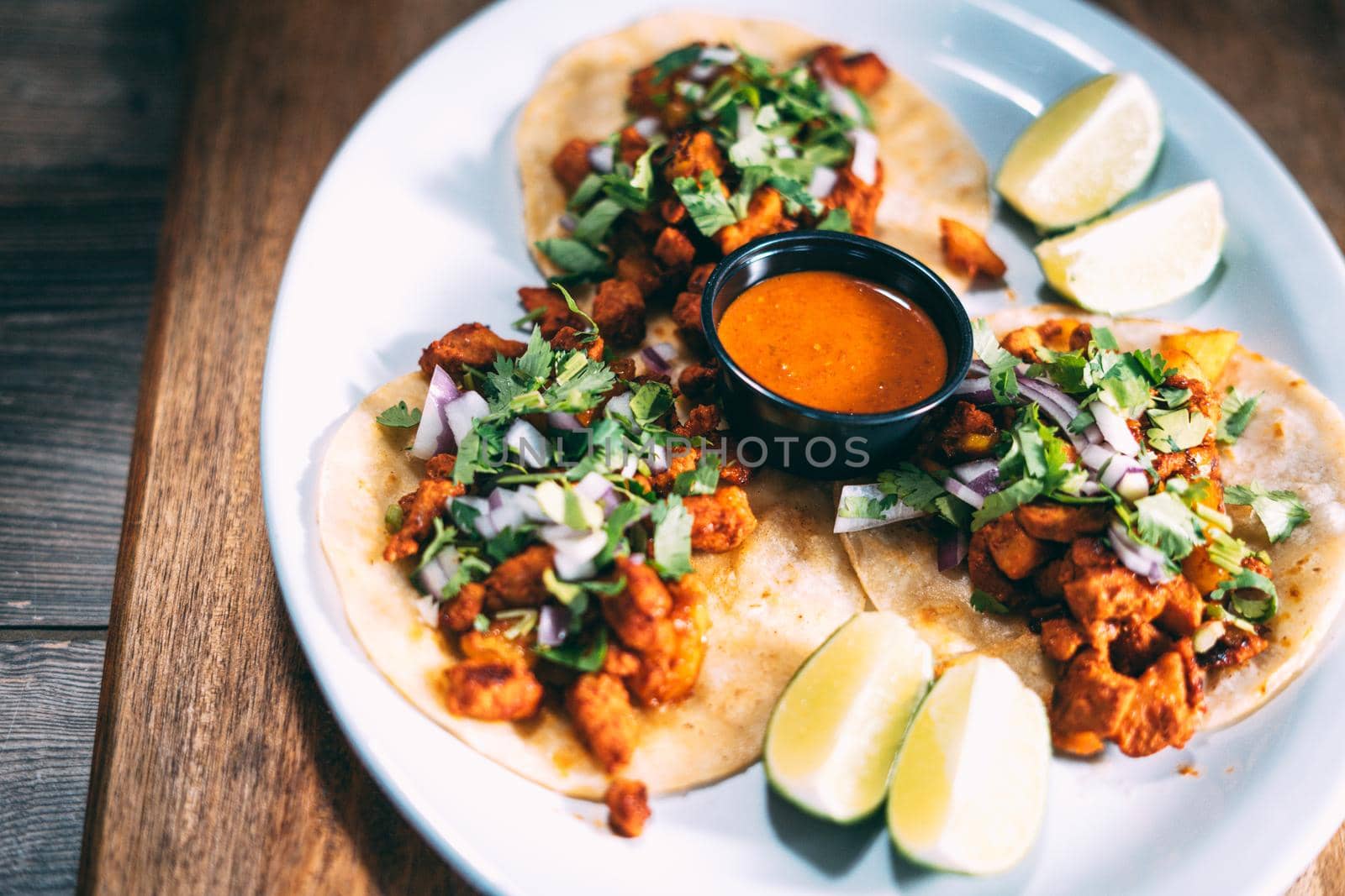 A plate of tacos and tortilla snacks