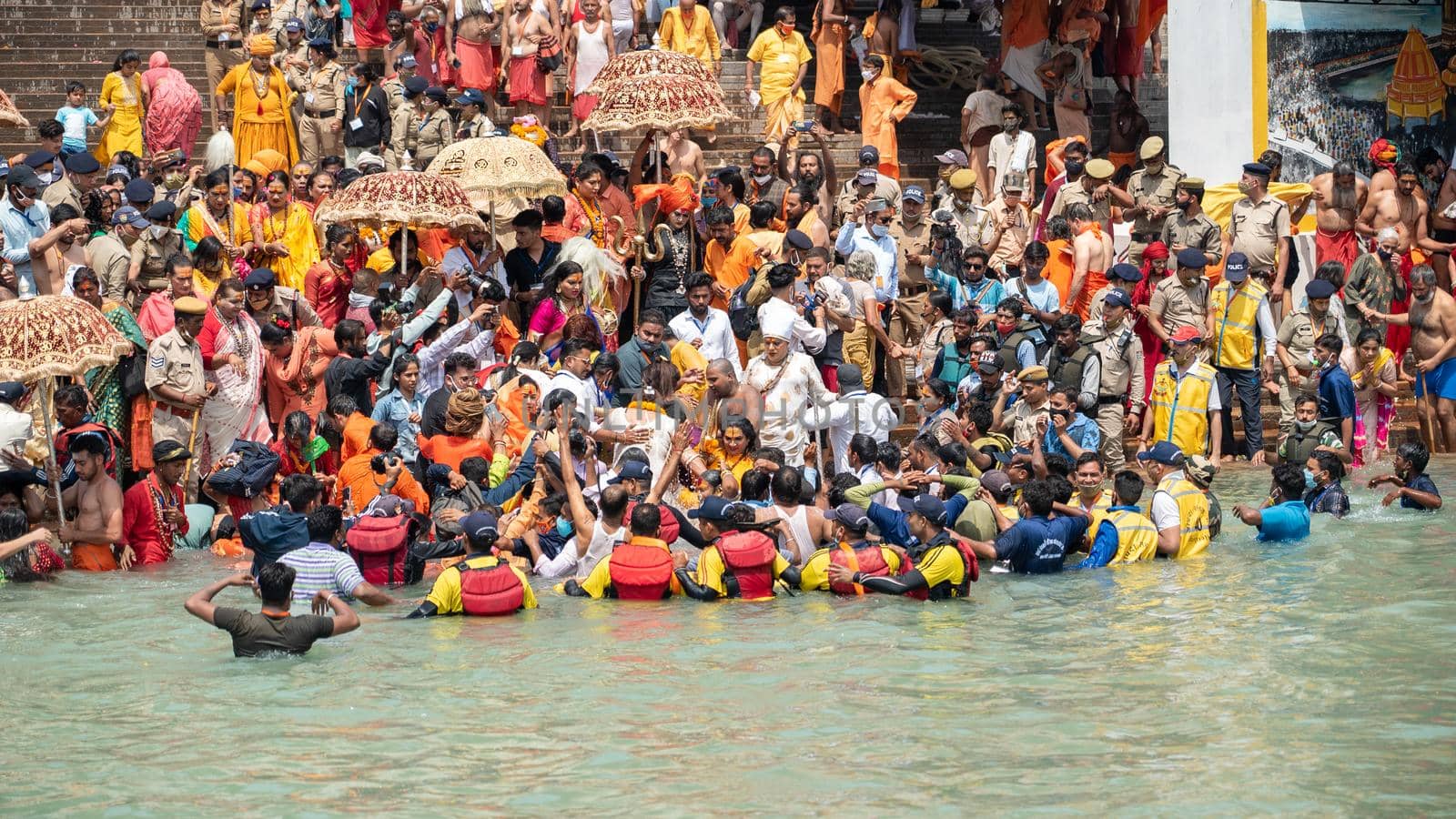 Haridwar, Uttarakhand India April 06, 2021. A Dip of Spirituality and faith, Maha Kumbh 2021. Morning Time dip, Indian saints batting in Ganges of Ganga River and Worshipping their God. High-quality