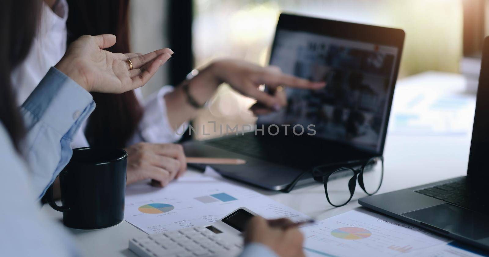 Business concept. Business people discussing the charts and graphs showing the results of their successful teamwork. by wichayada