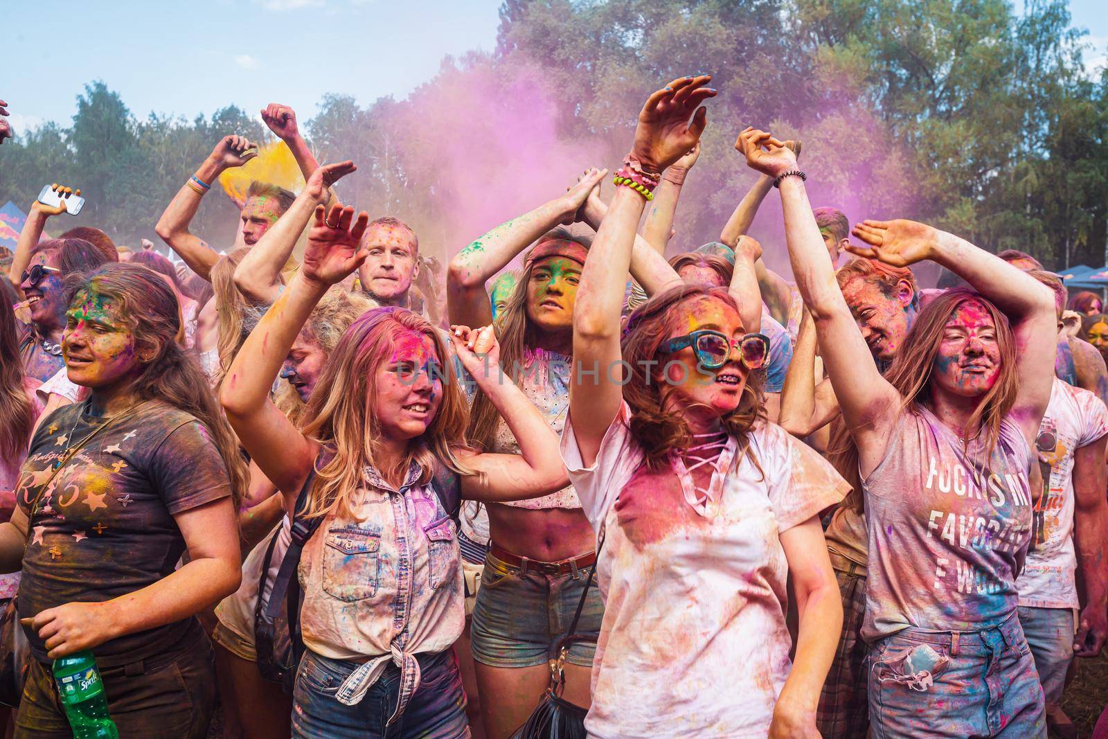 Holi colors holiday. Crazy crowd of young people having fun during festival of colors ColorFest in Kyiv, Ukraine