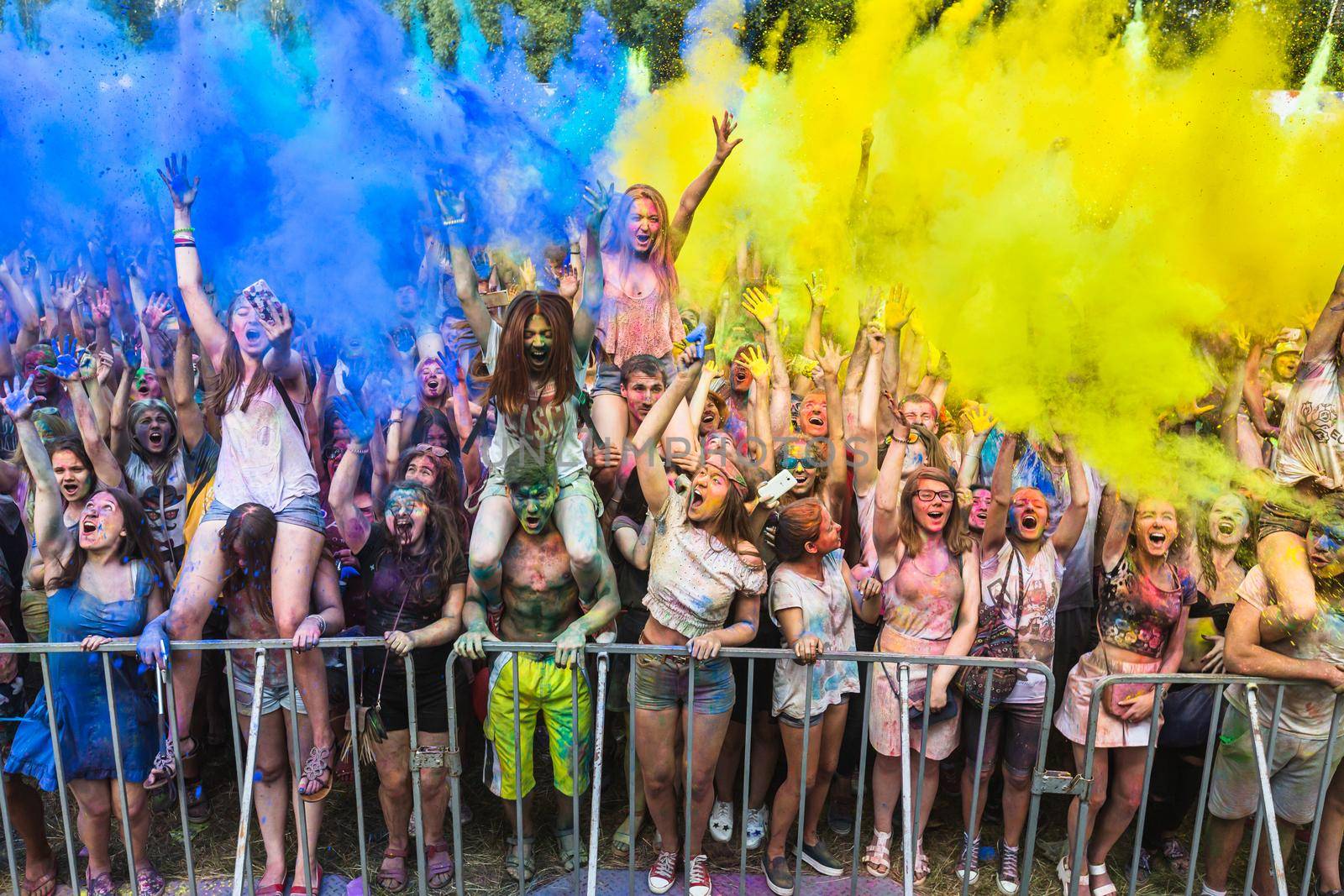 Holi colors holiday. Crazy crowd of young people having fun during festival of colors ColorFest in Kyiv, Ukraine