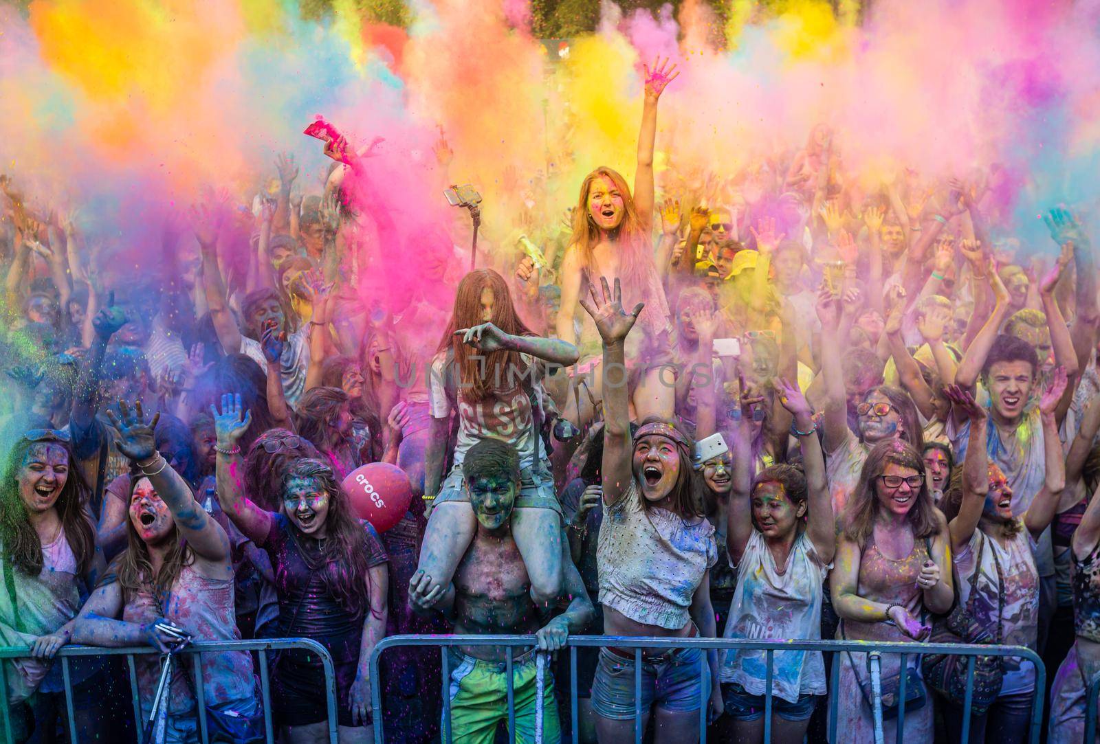 Holi colors holiday. Crazy crowd of young people having fun during festival of colors ColorFest in Kyiv, Ukraine