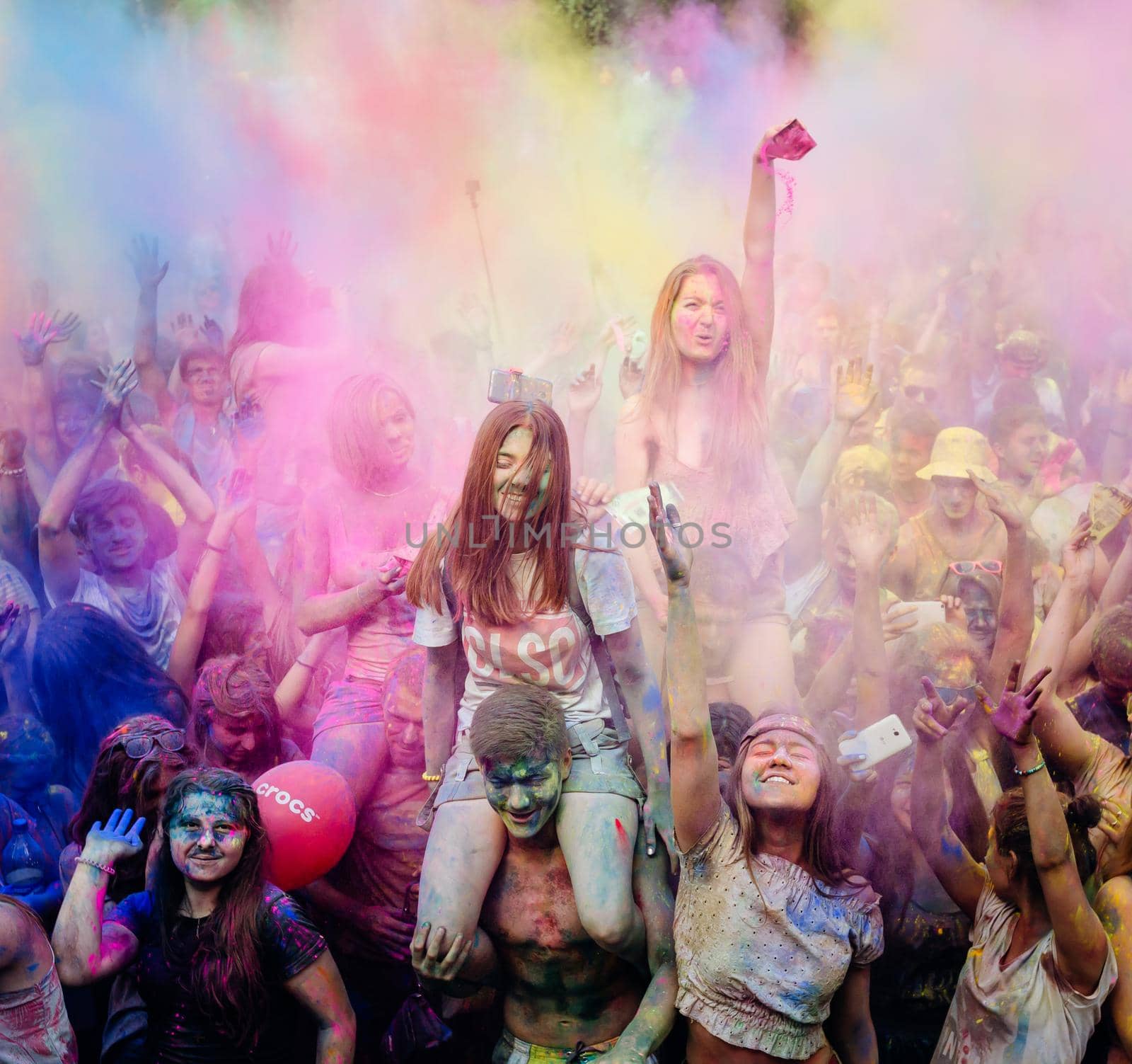 Holi colors holiday. Crazy crowd of young people having fun during festival of colors ColorFest in Kyiv, Ukraine