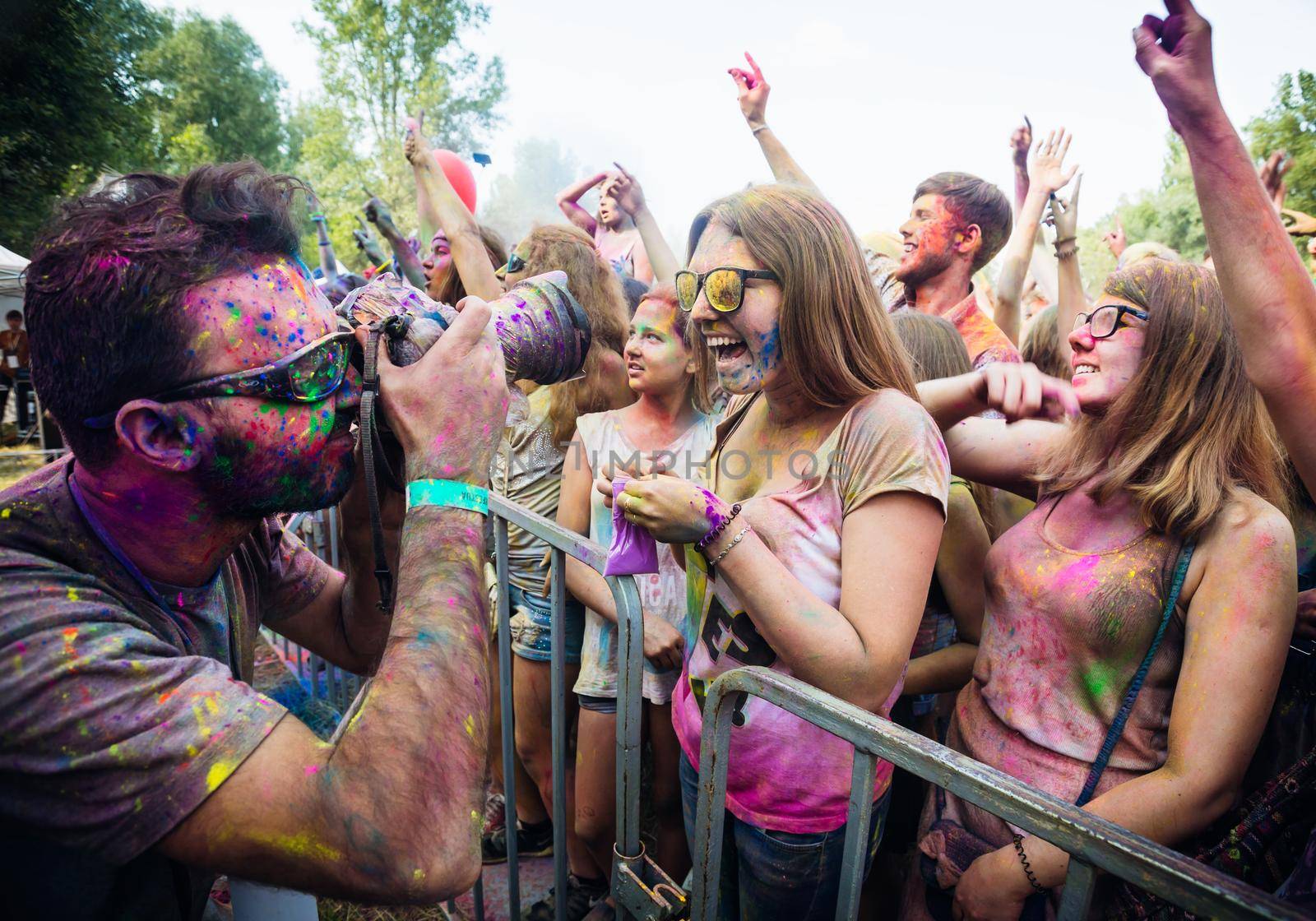 Holi colors holiday. Crazy crowd of young people having fun during festival of colors ColorFest in Kyiv, Ukraine