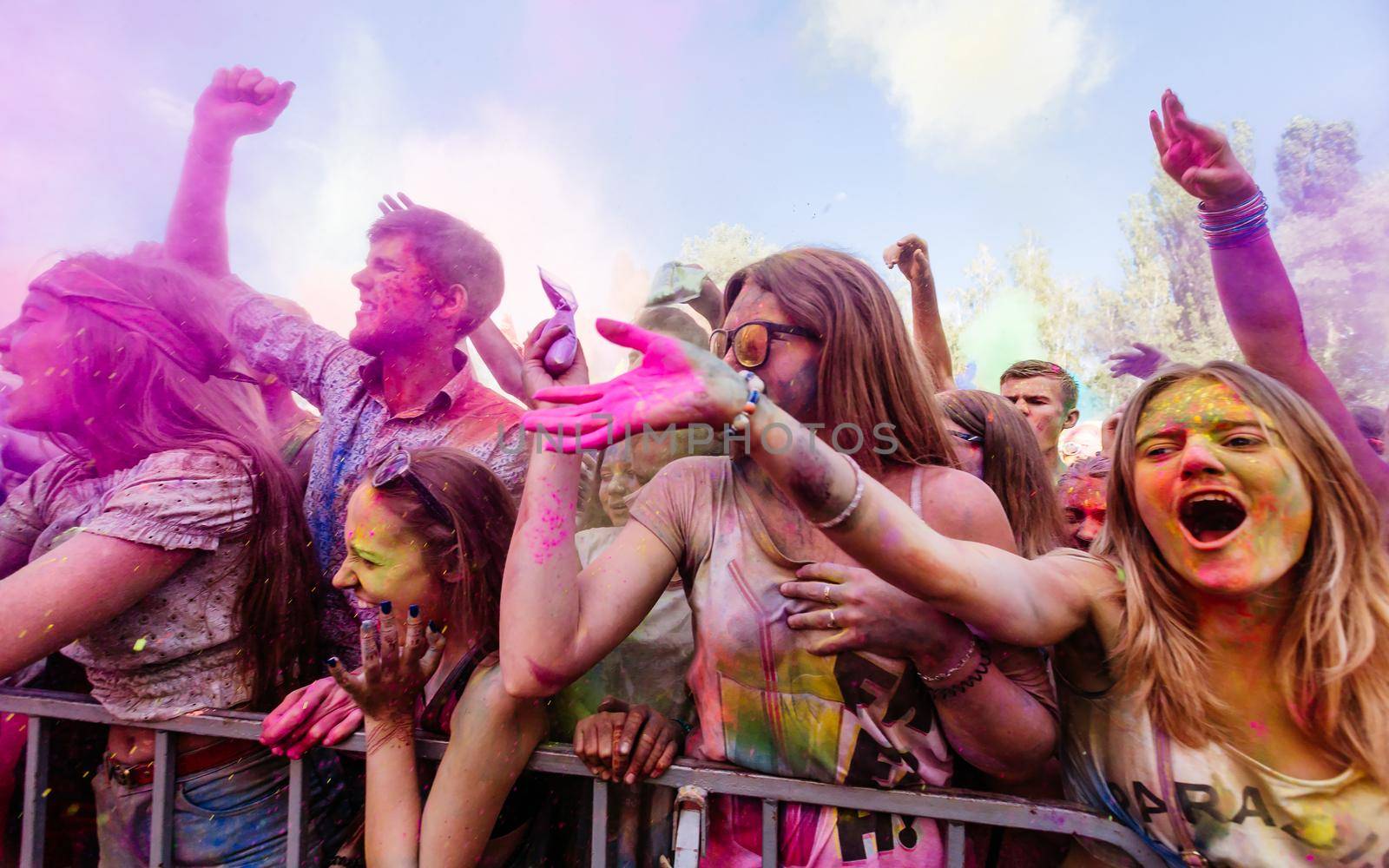 Holi colors holiday. Crazy crowd of young people having fun during festival of colors ColorFest in Kyiv, Ukraine