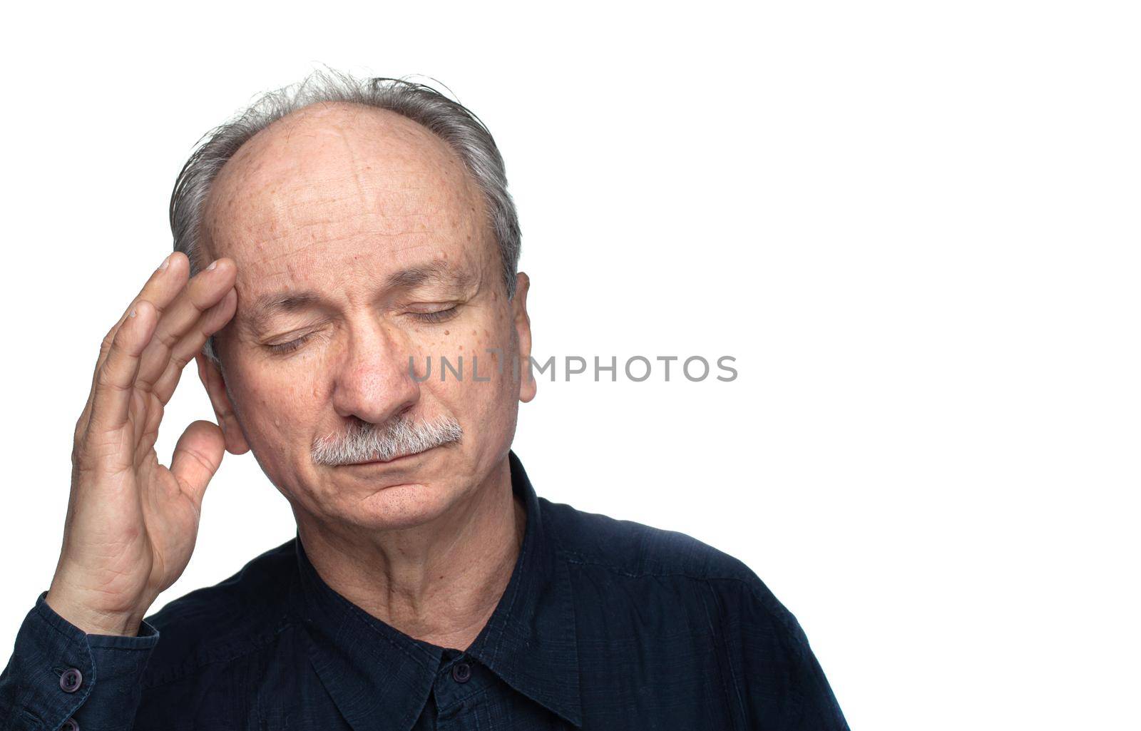 Health and illness concept. Elderly man suffers from headache and holds his head by hand isolated on white with copy space