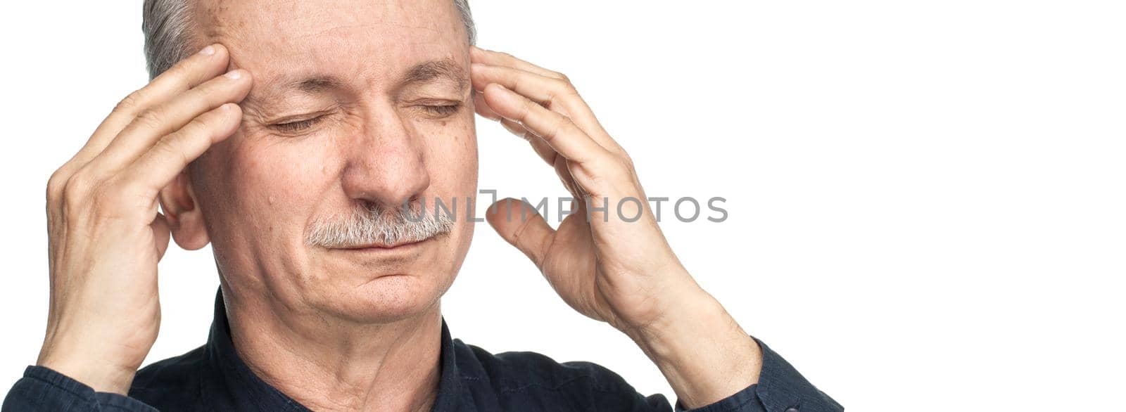 Elderly man suffering from a headache isolated on white background with copy-space