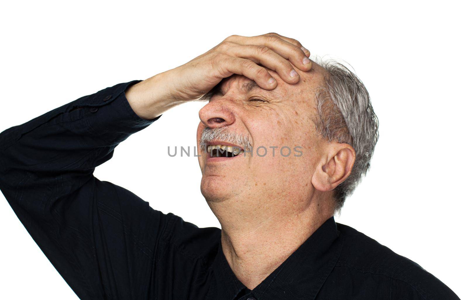 Health and illness concept. Elderly man suffers from headache and holds his head by hand isolated on white with copy space