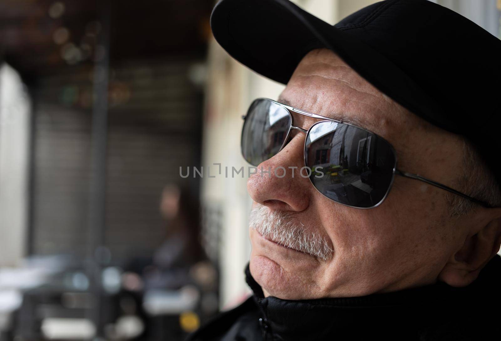 Portrait of an elderly man in profile in sunglasses