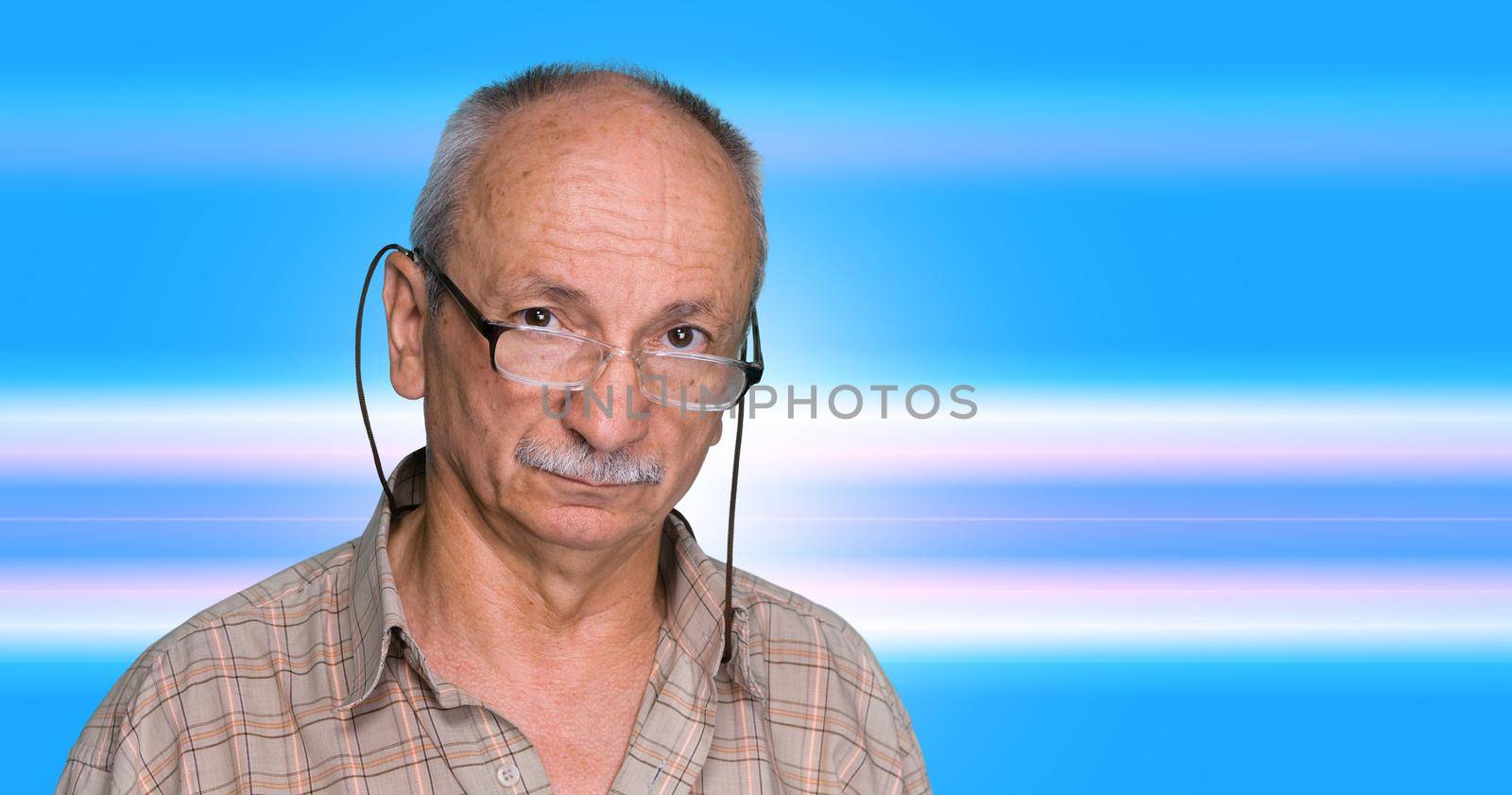 An elderly man with glasses on a blue abstract background
