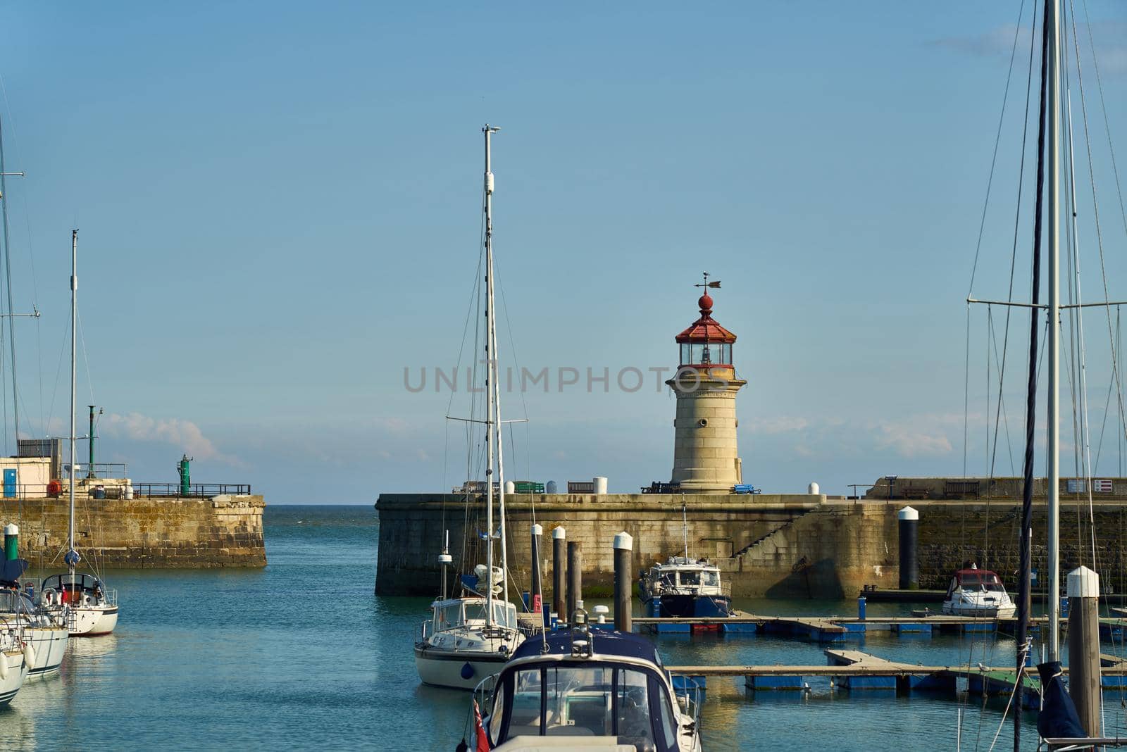 Ramsgate, United Kingdom - April 30, 2021: Ramsgate Lighthouse stands next to the main harbour entrance. by ChrisWestPhoto