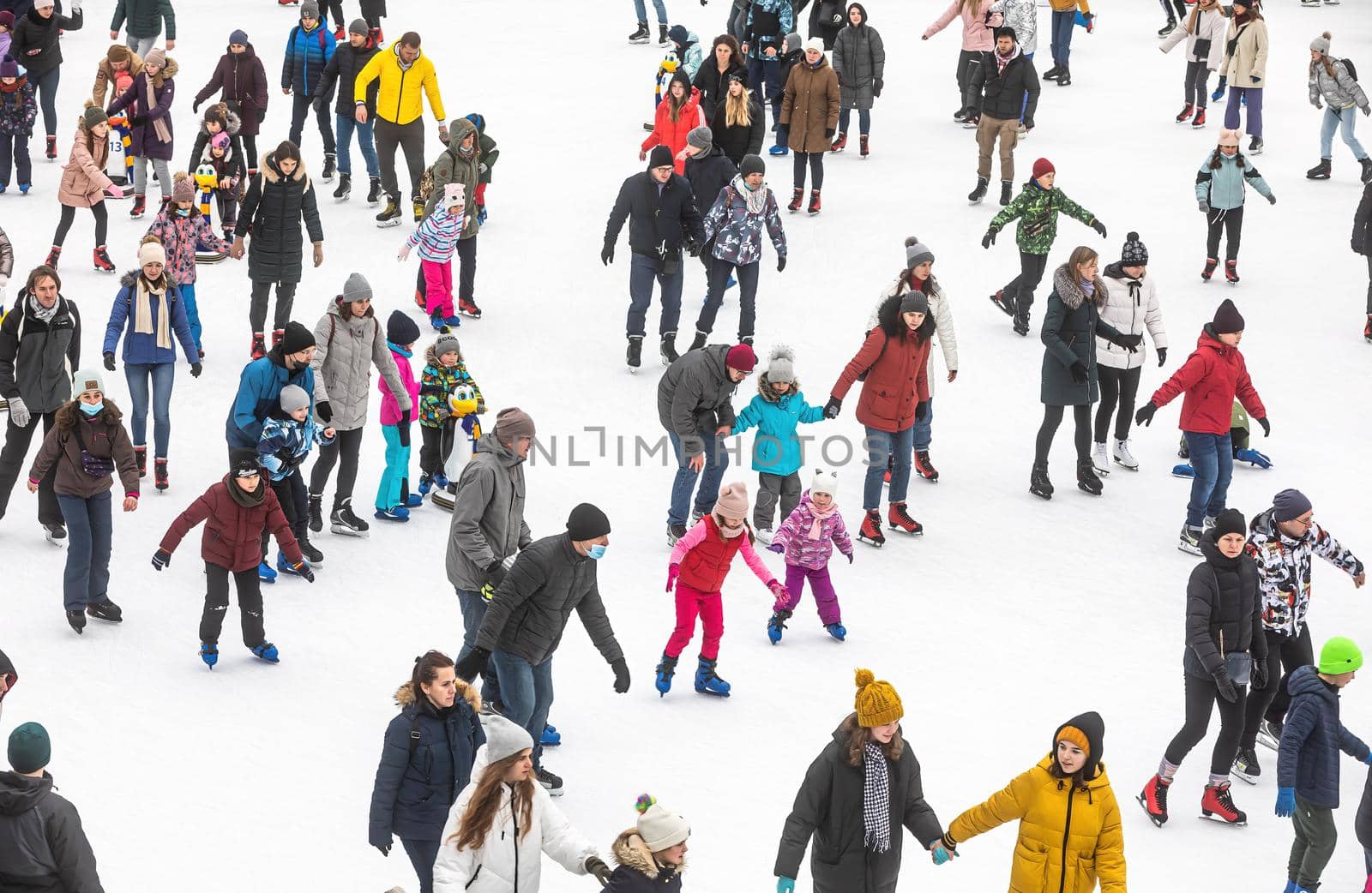 KYIV, UKRAINE - Jan. 03, 2021: Ice-skating people. People have fun in ice arena at the city ice rink. New Years holidays in city Kyiv.