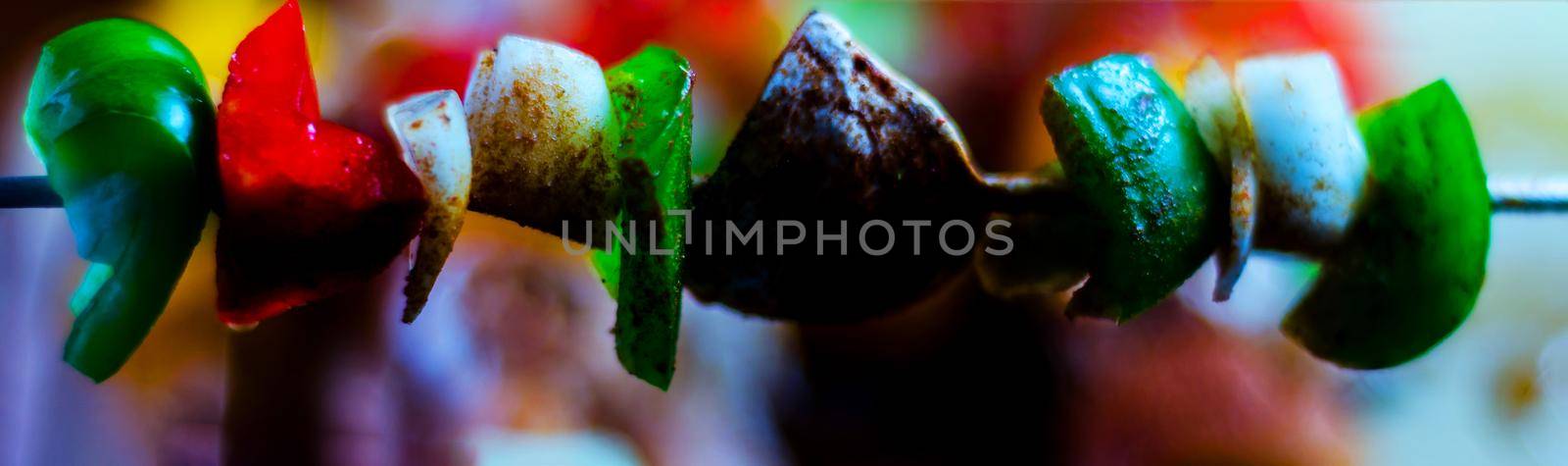 skewers with meat and vegetables prepared for grilling on a wooden board by Q77photo