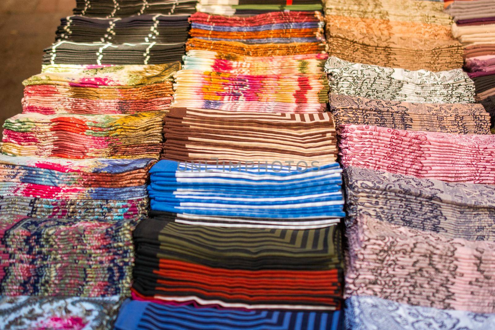 Pile of bright Multi-colored pieces of fabric in a bazaar