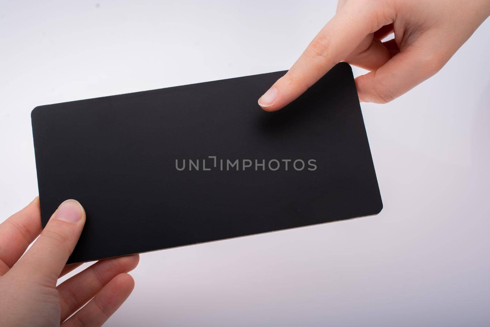 Rectangular shaped black notice board in hand on white background