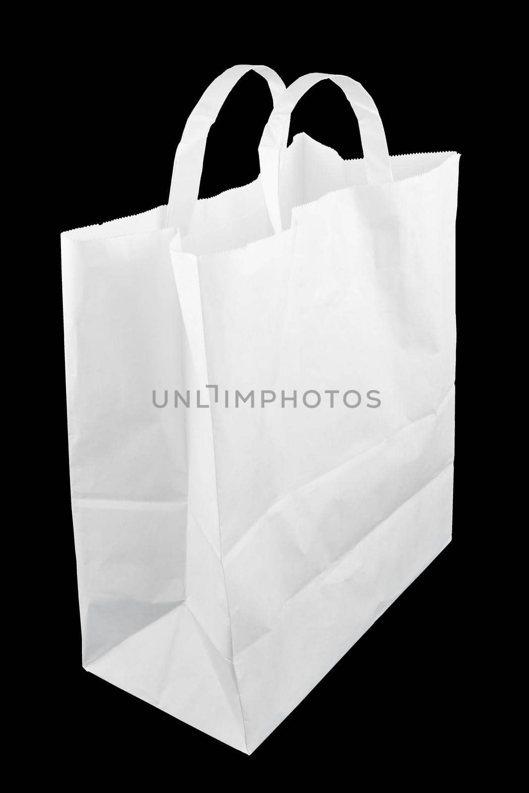 used white paper bag with handles isolated on black background.