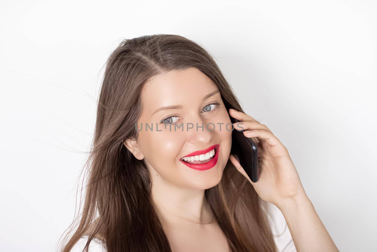 Happy smiling woman calling on smartphone, portrait on white background. People, technology and communication concept.