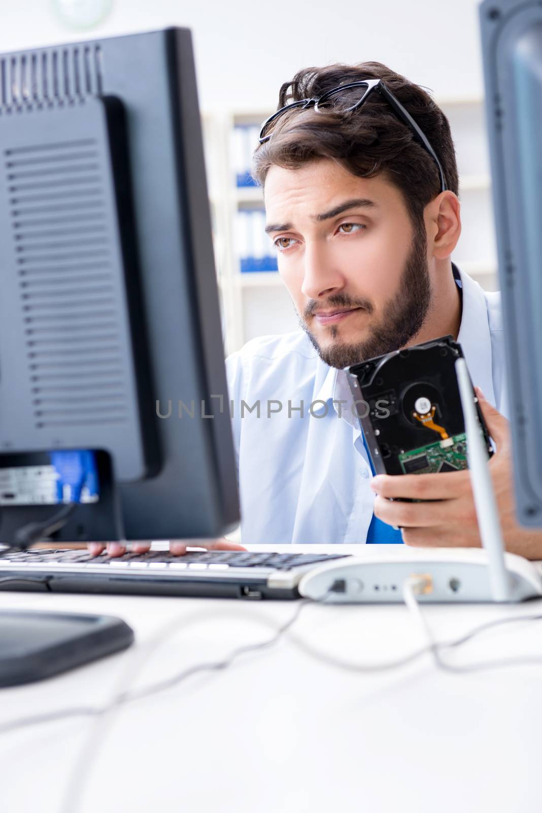 Technician with broken hard drive