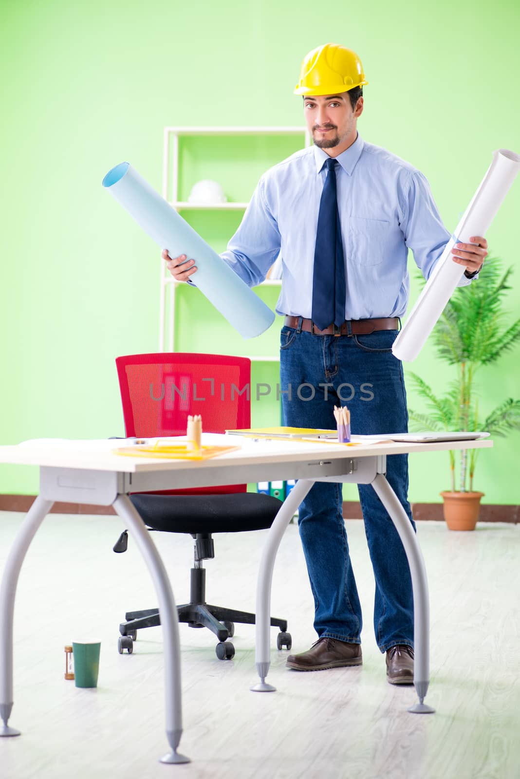 Young male architect working at the project