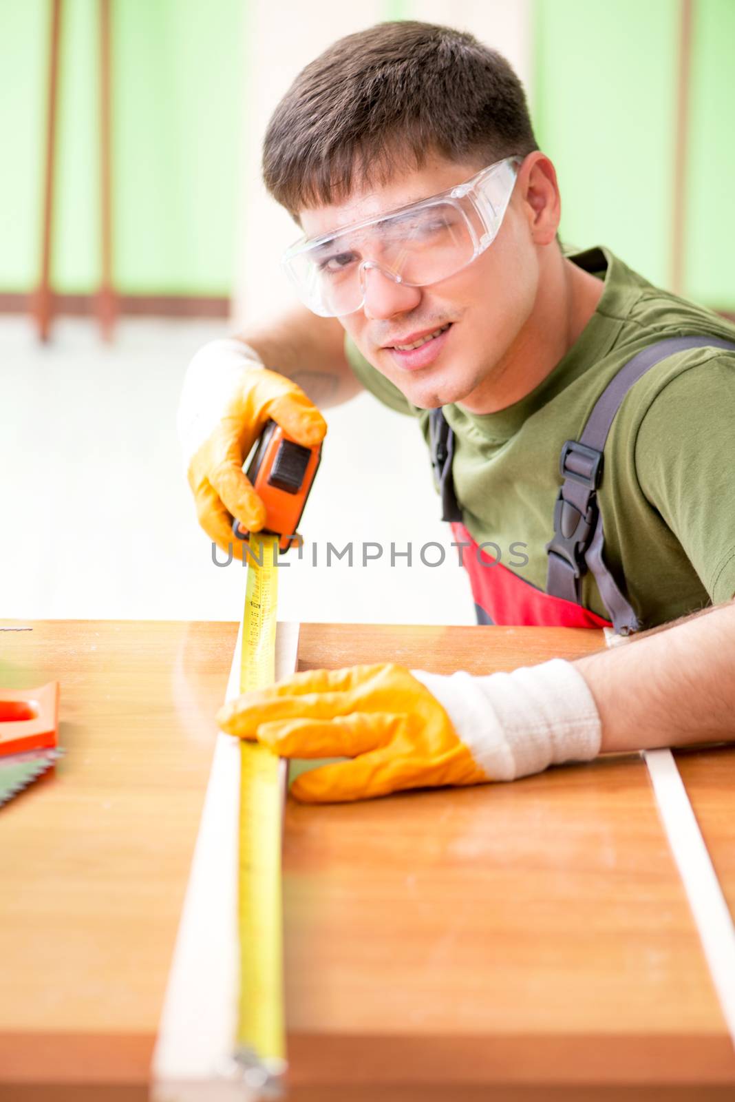 Young man carpenter working in workshop 