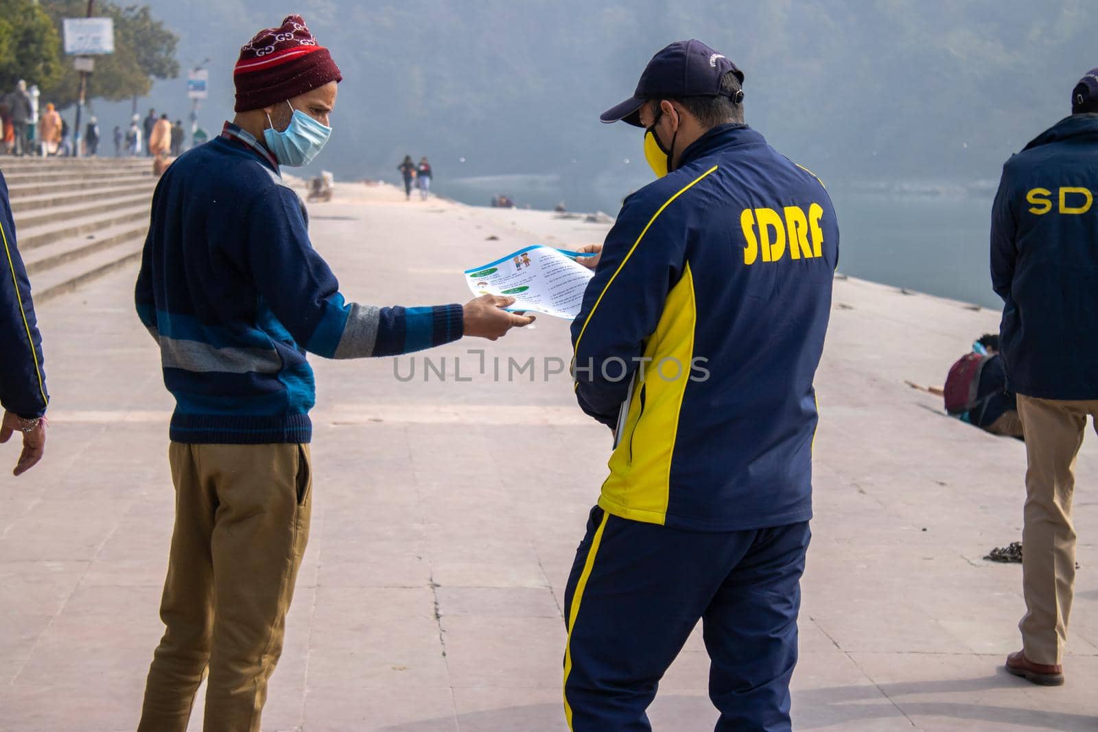 Policemen spreading awareness of protection from Coronavirus to stay safe from Coronavirus during Maha Kumbh 2021 by stocksvids